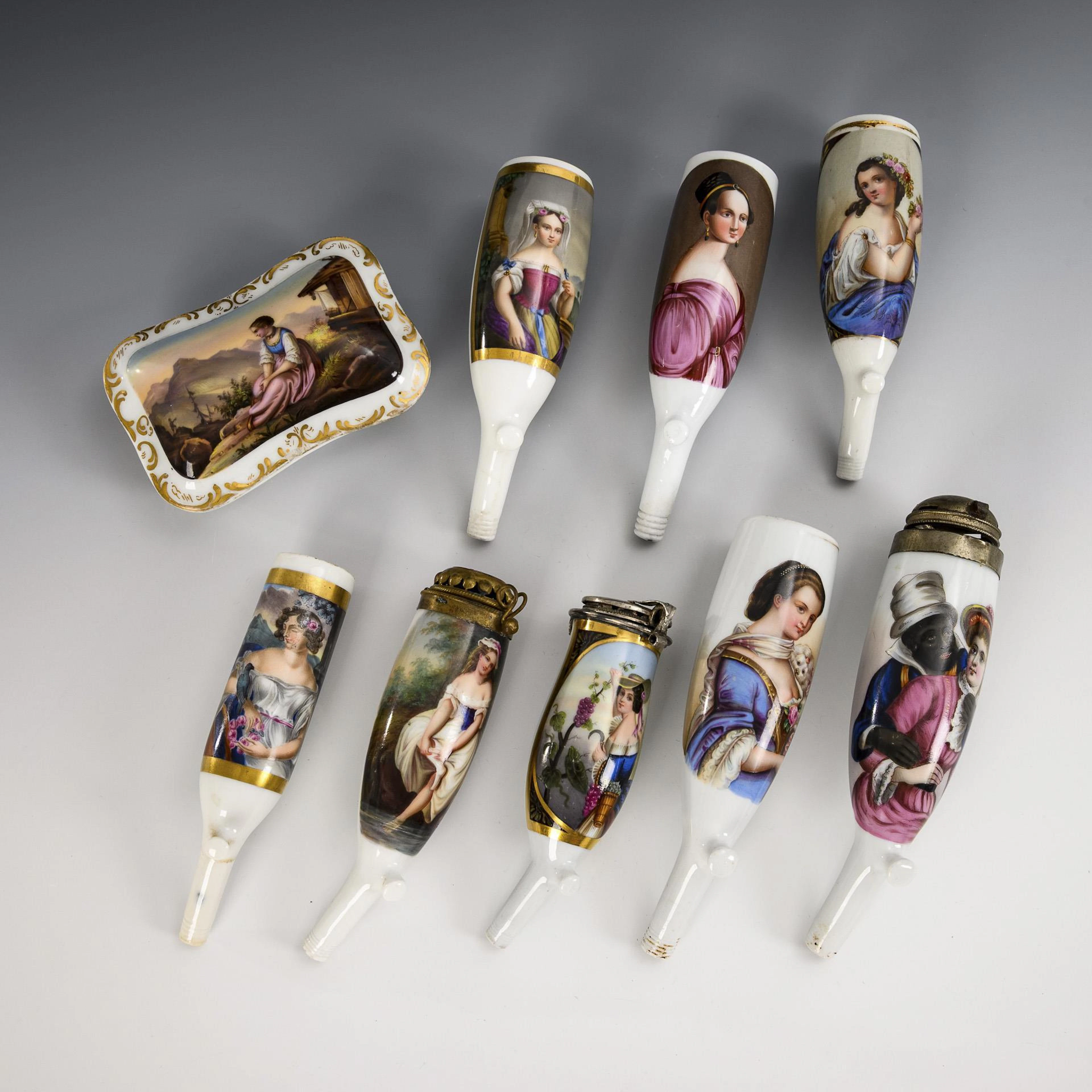 8 pipe bowls and 1 matchbox with portraits of women.