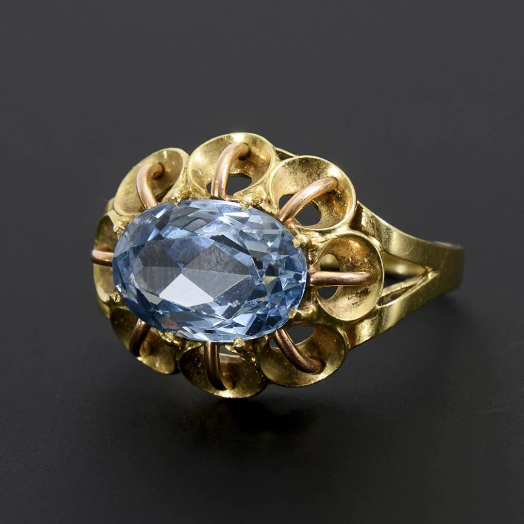 Ring with a blue gemstone.