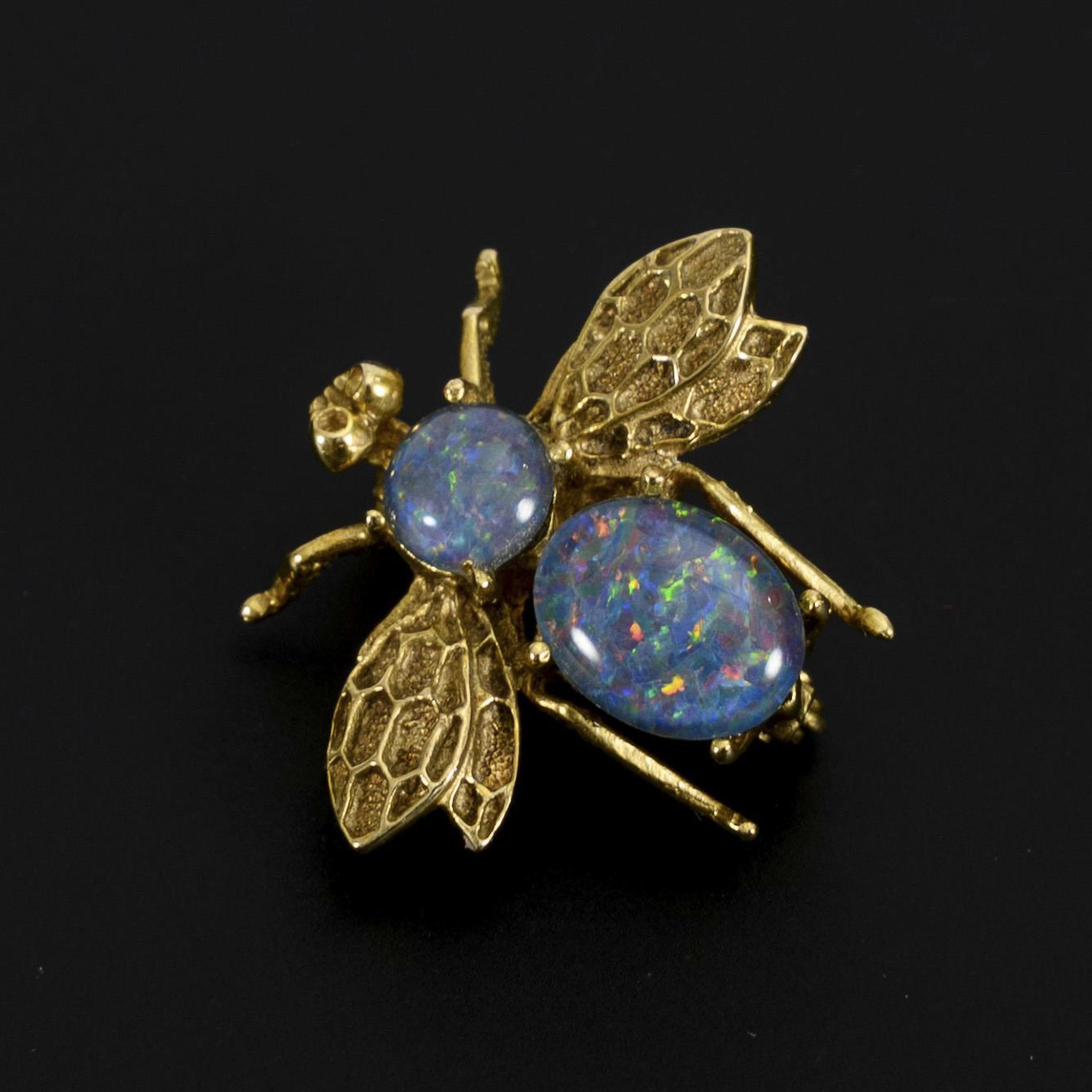 Bee-shaped brooch with opal doublets.