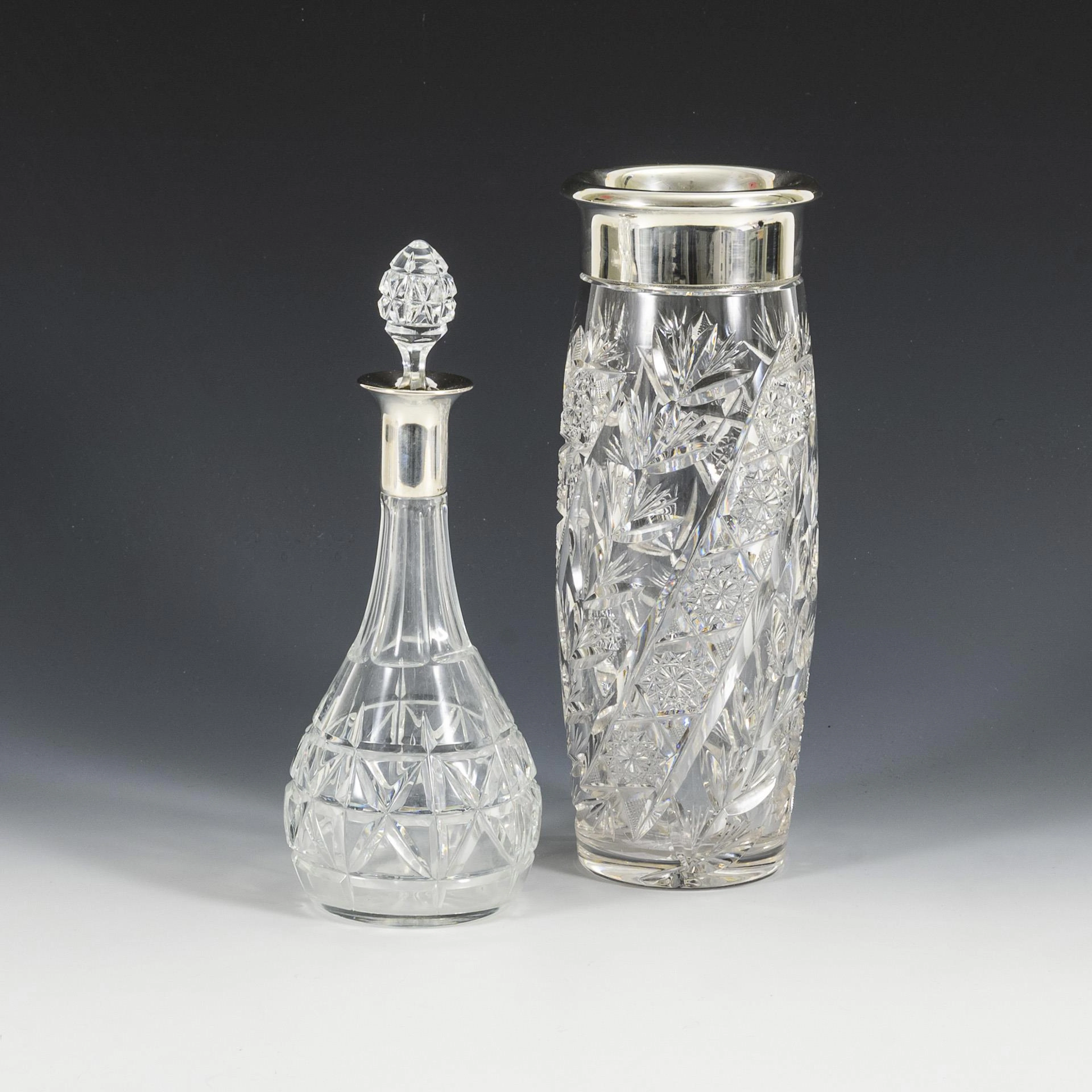 Crystal vase and carafe with silver rim. . Silver, clear glass. H max. 29.2 cm