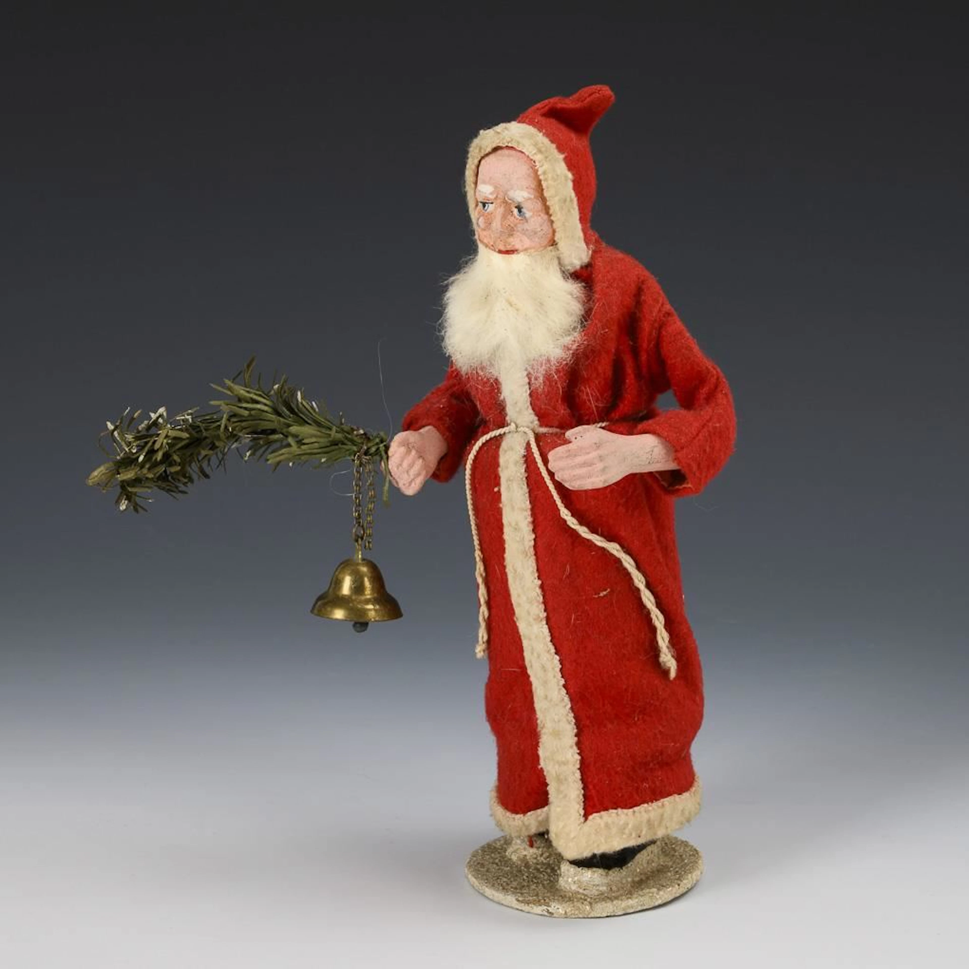 Santa Claus with a fir branch and bells.