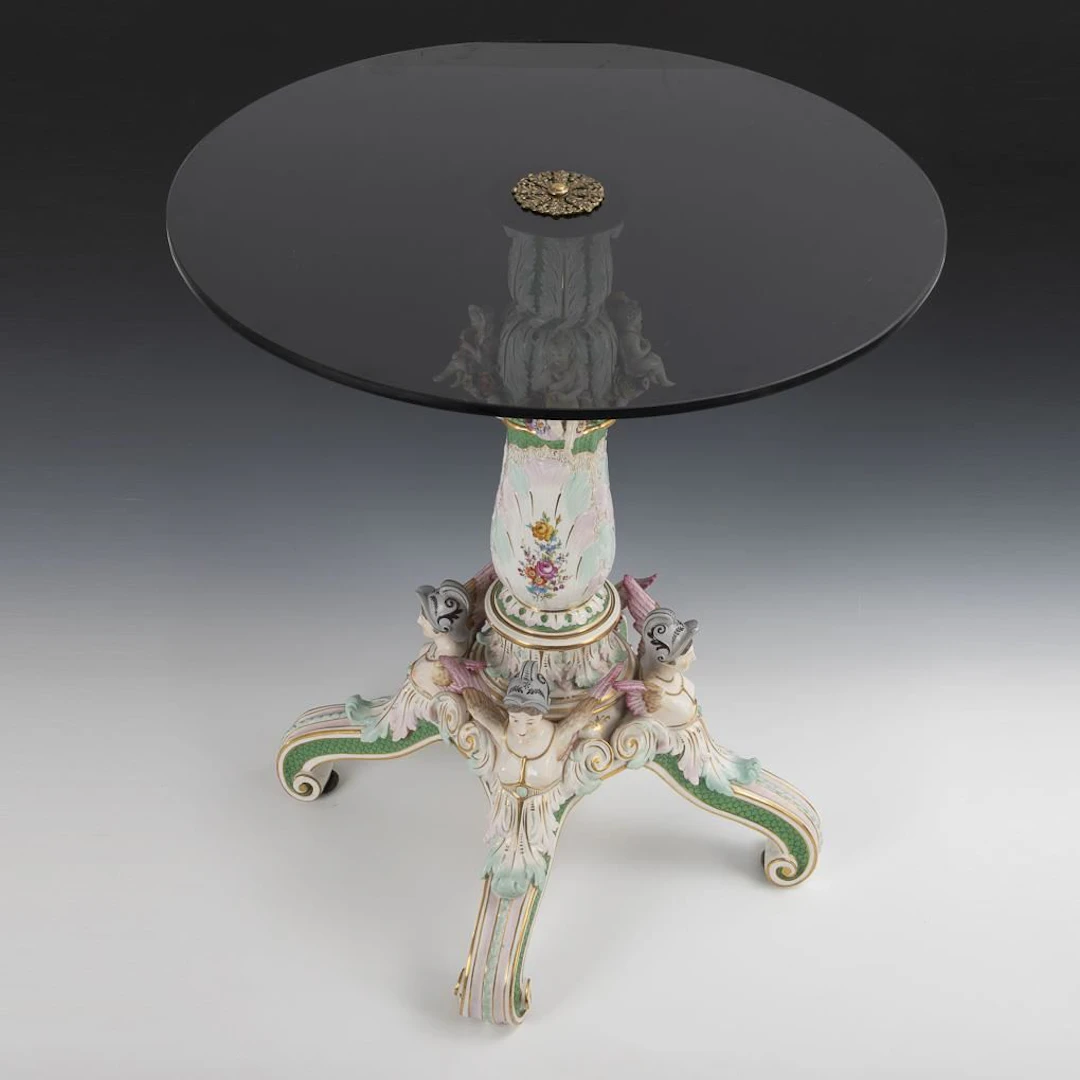 Porcelain table with glass top.