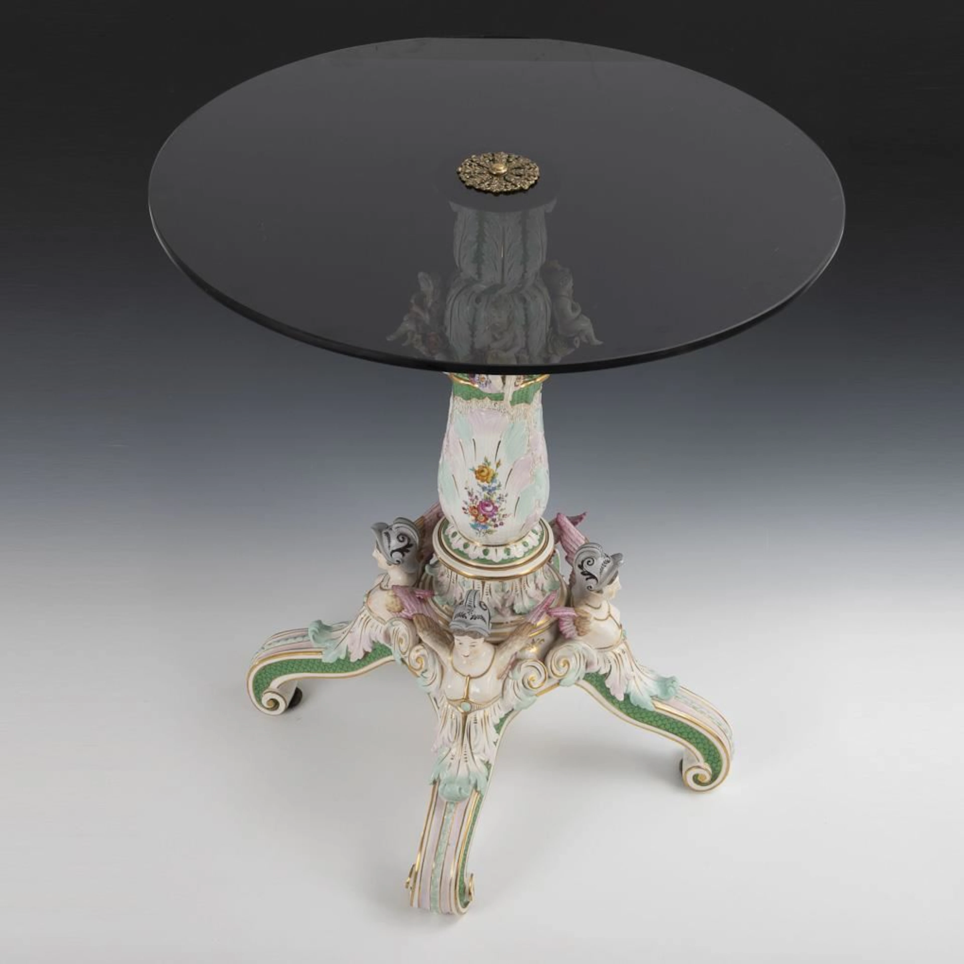 Porcelain table with glass top.