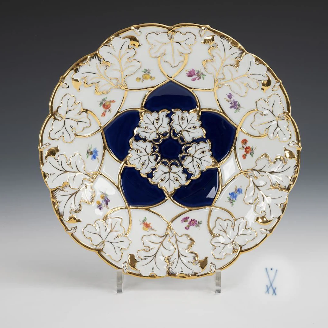 Ornamental bowl with cobalt partial ground and scattered flower decoration.