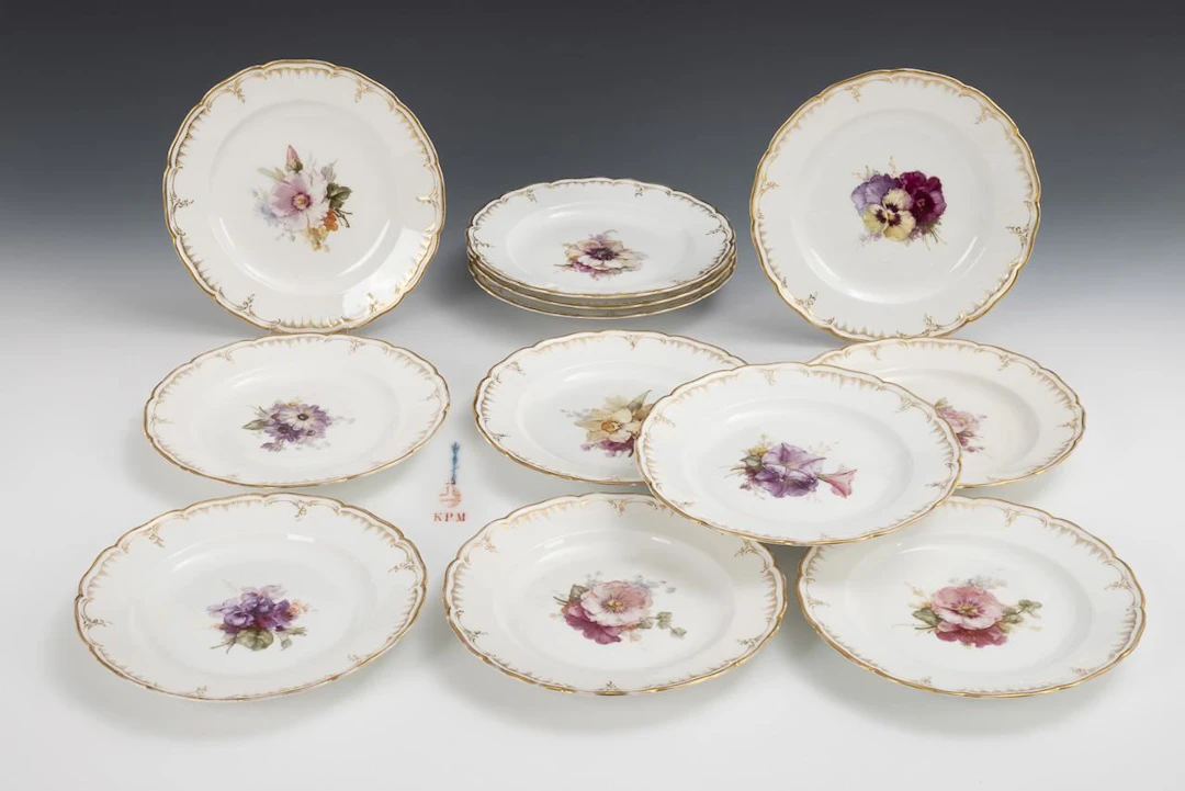 12 plates with floral designs. KPM Berlin.