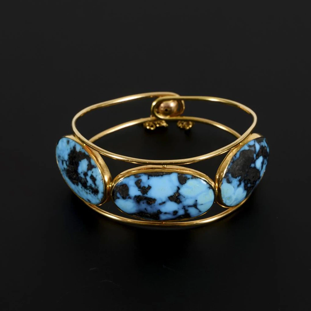 Bangle with turquoise cabochons.