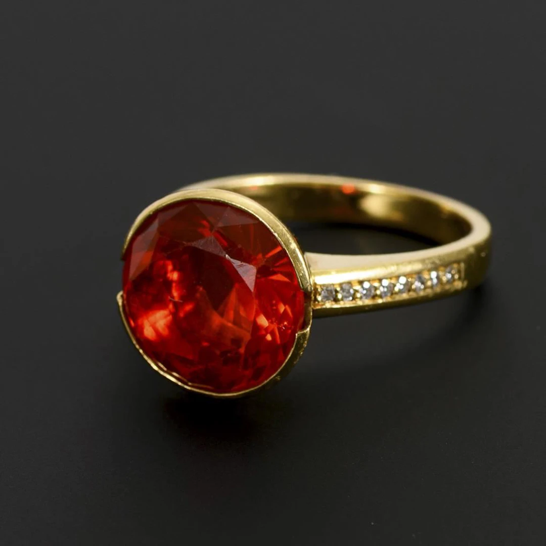 Ring with a large fire opal and brilliant-cut diamonds.