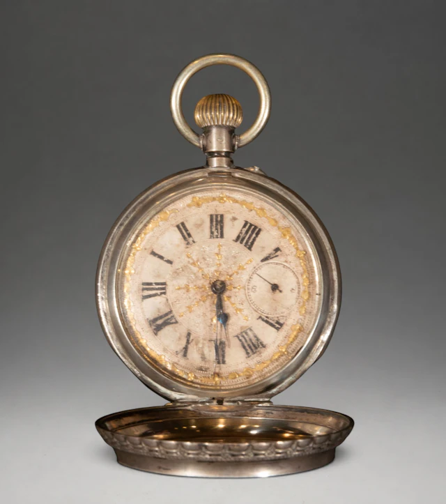 Silver-plated metal pocket watch with enamel dial and Roman numerals