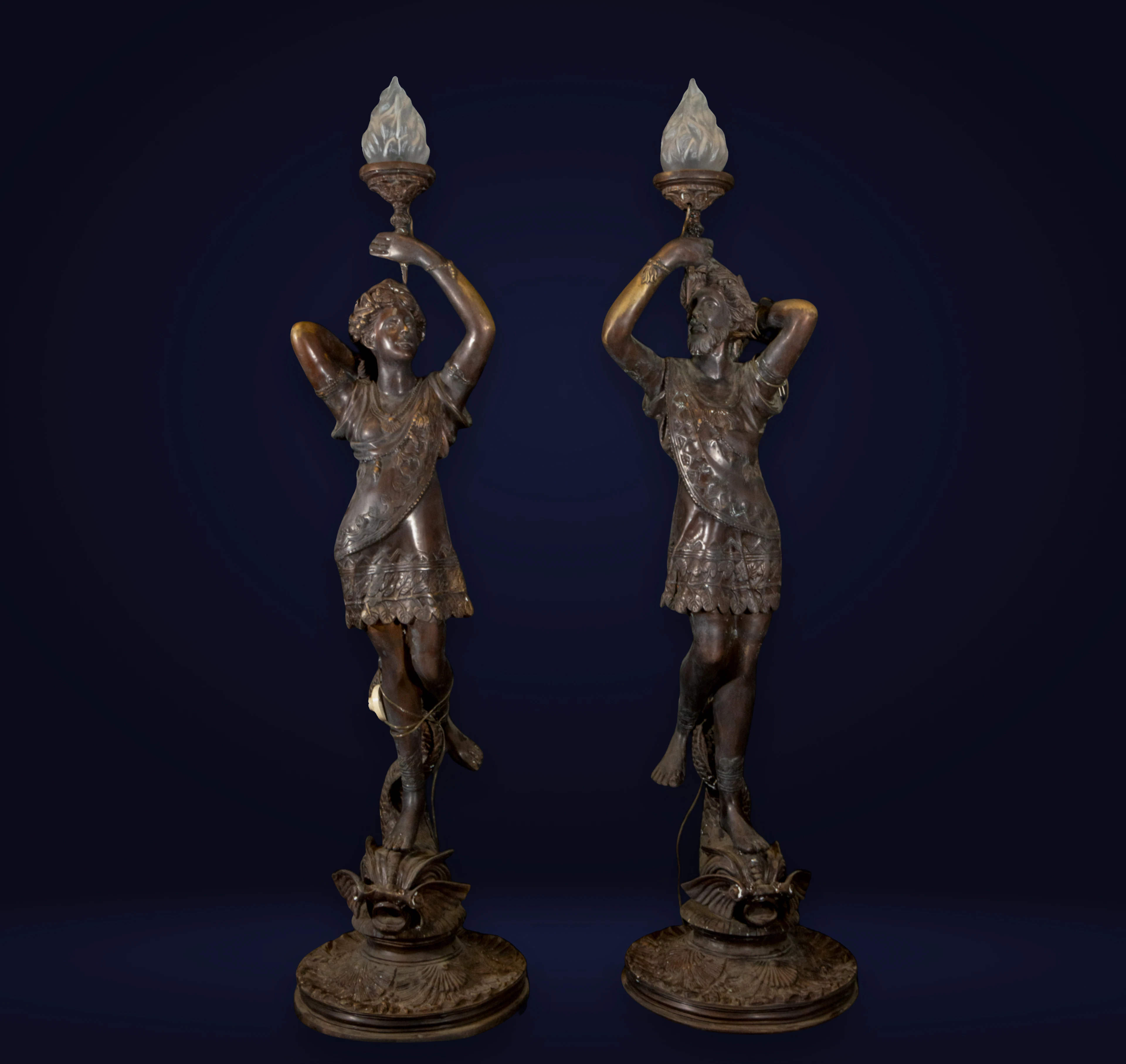 Pair of monumental Art Nouveau torch holders in patinated bronze