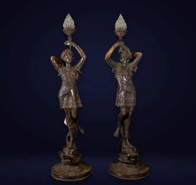 Pair of monumental Art Nouveau torch holders in patinated bronze