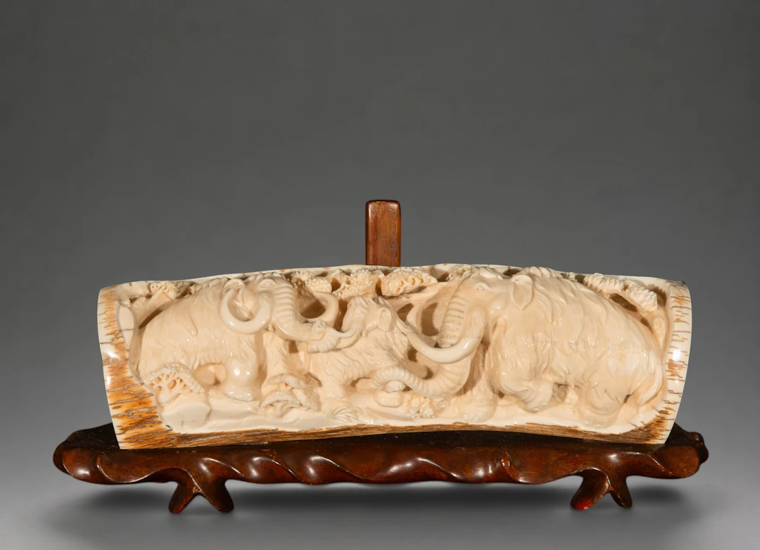 Mammoth tusk carved with elephants, signed – China – 20th century