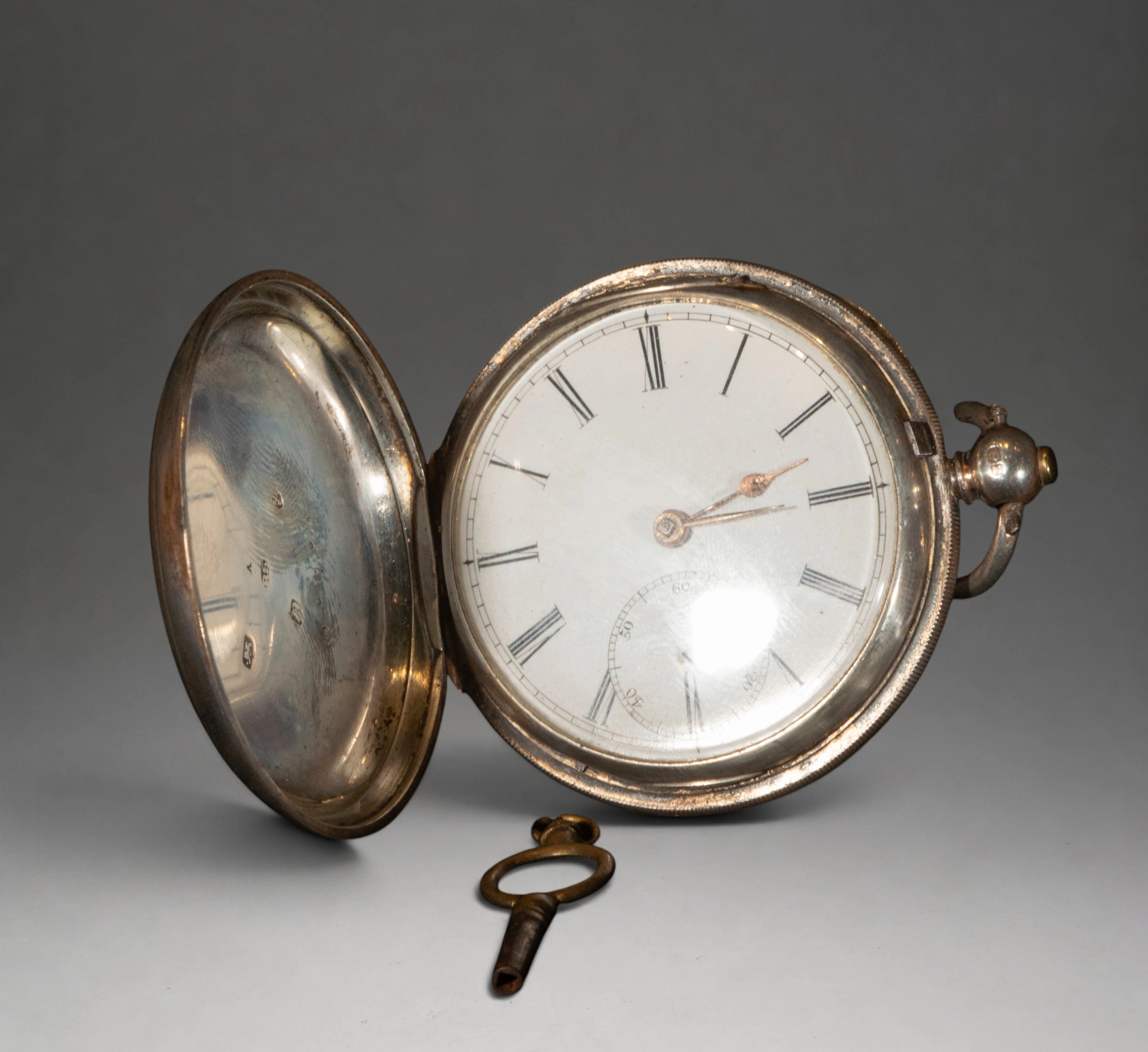Pocket watch with decorated cover and Roman numerals