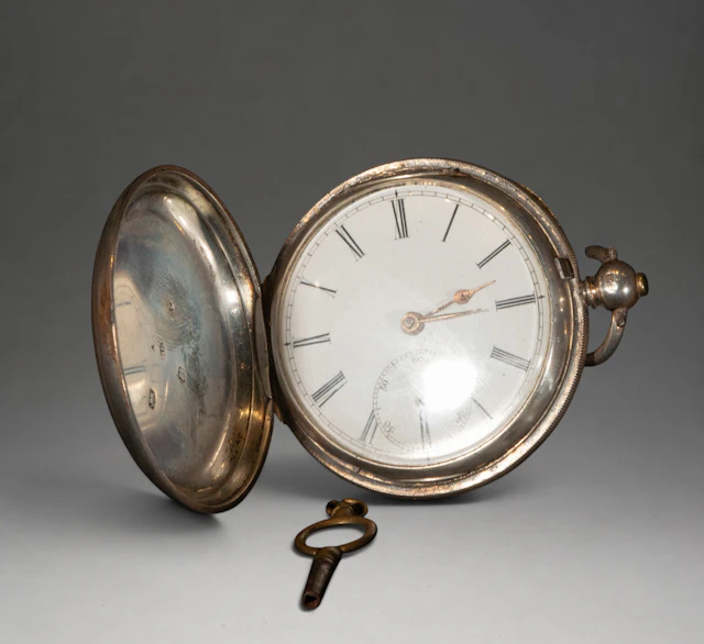 Pocket watch with decorated cover and Roman numerals