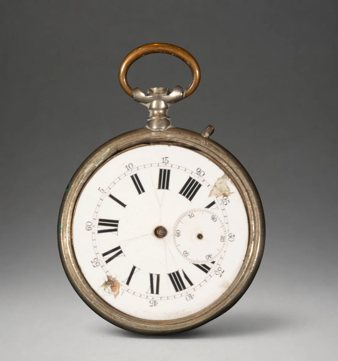 Gold pocket watch with white dial