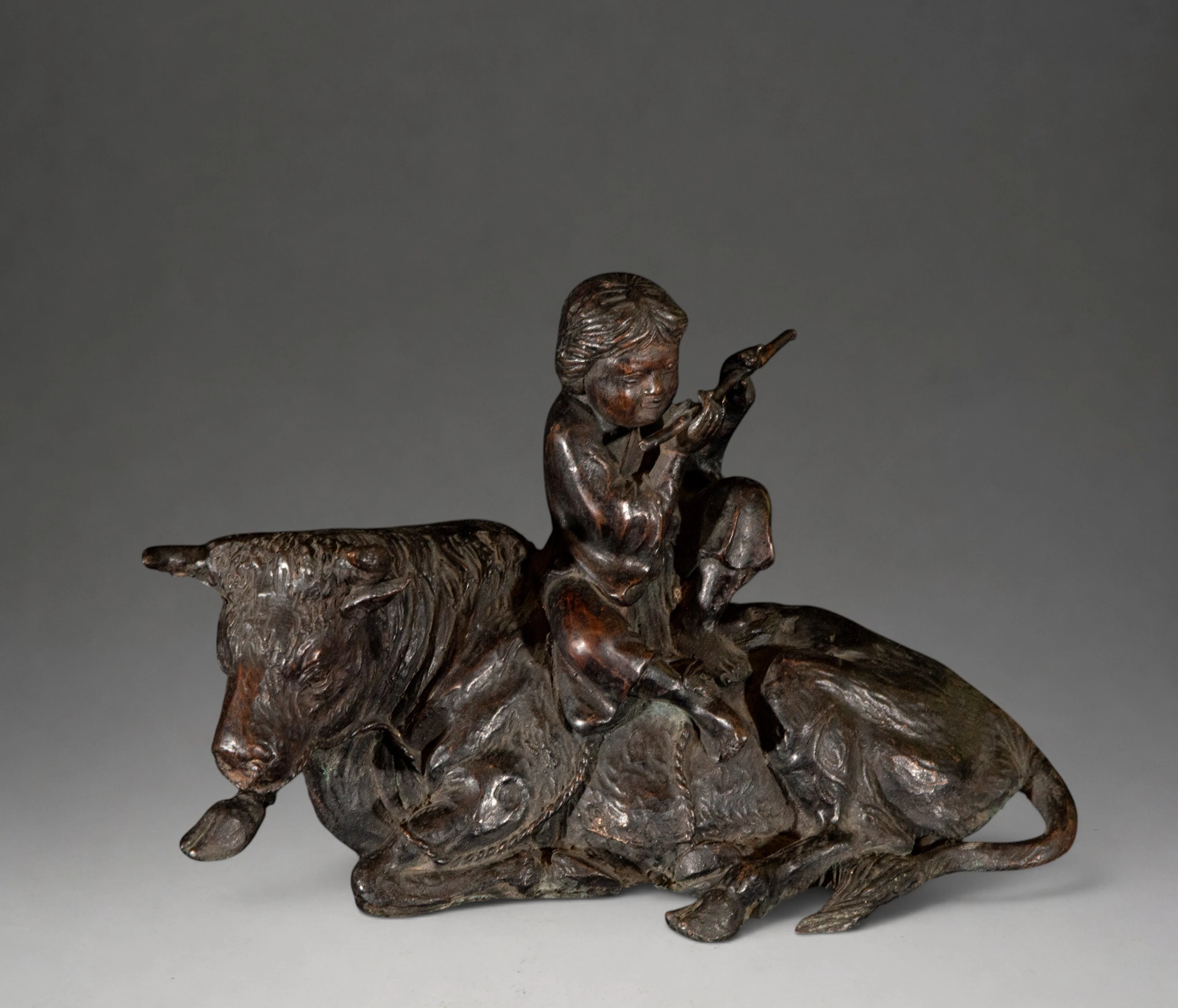 Young shepherd playing the flute next to two cows – French School