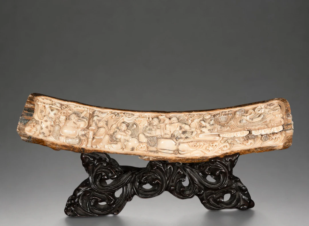 Mammoth tusk carved with auspicious figures and motifs, signed – China