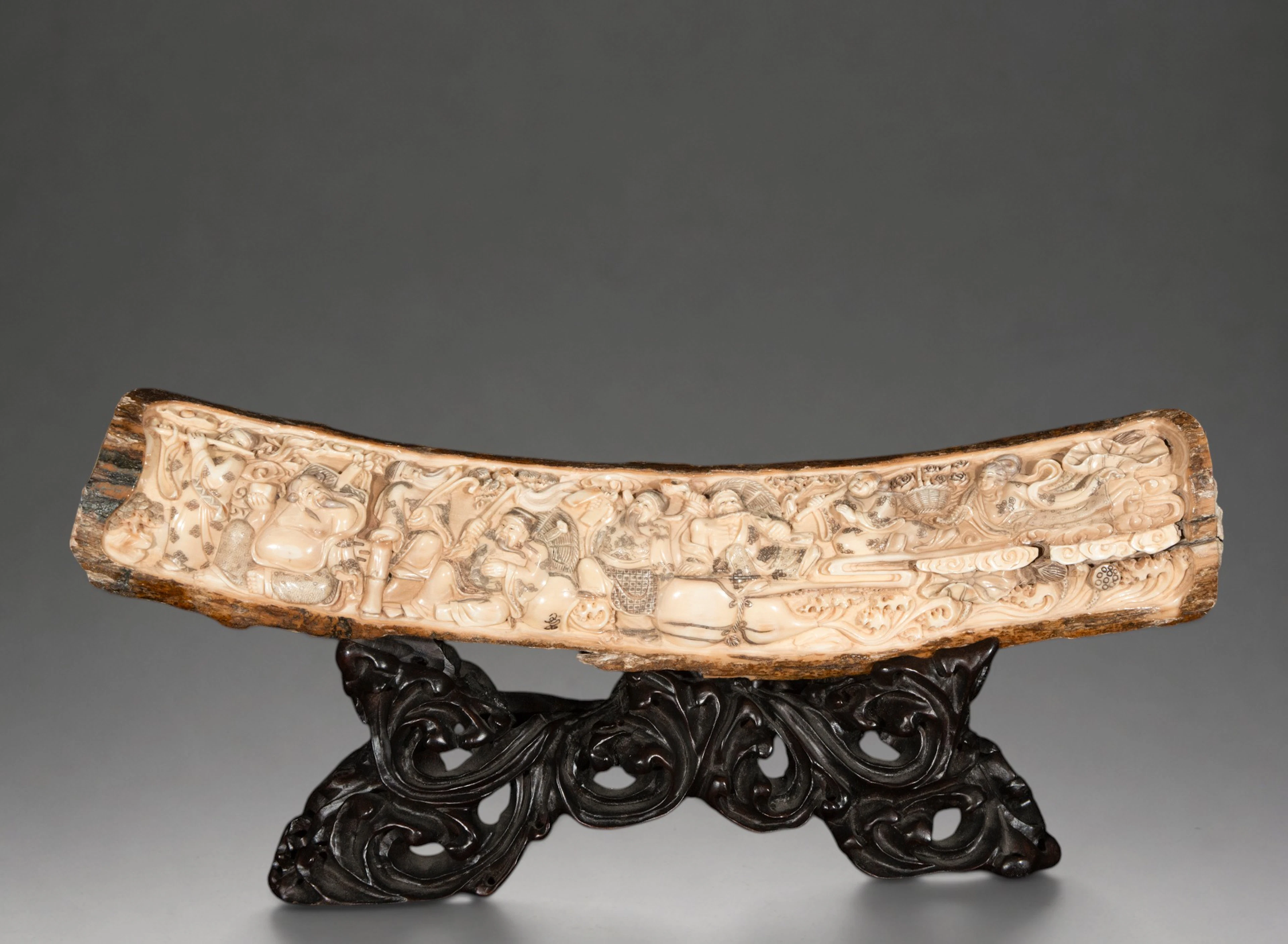 Mammoth tusk carved with auspicious figures and motifs, signed – China