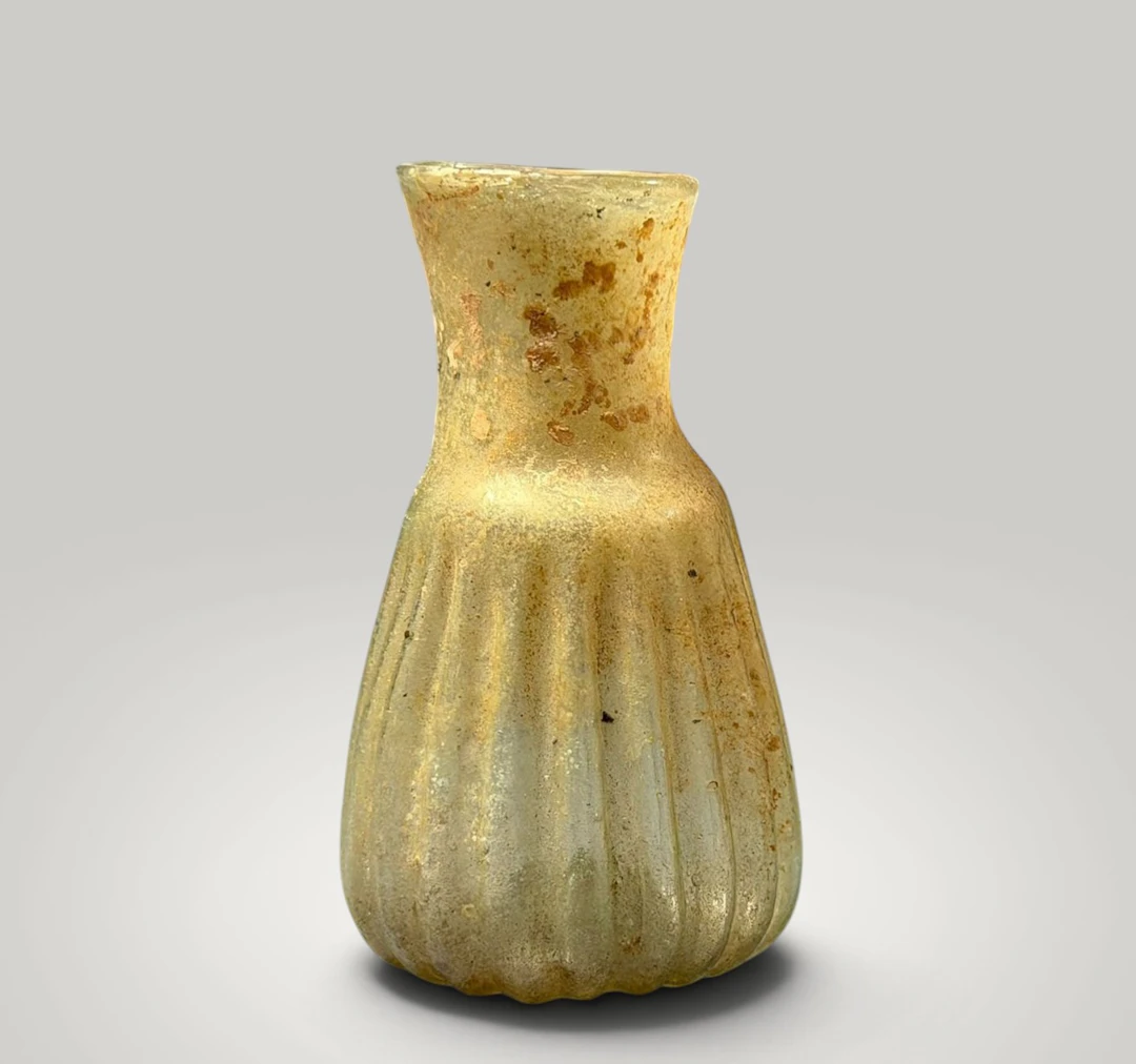 Blown glass unguentarium with fluted body. Roman culture, 2nd-3rd