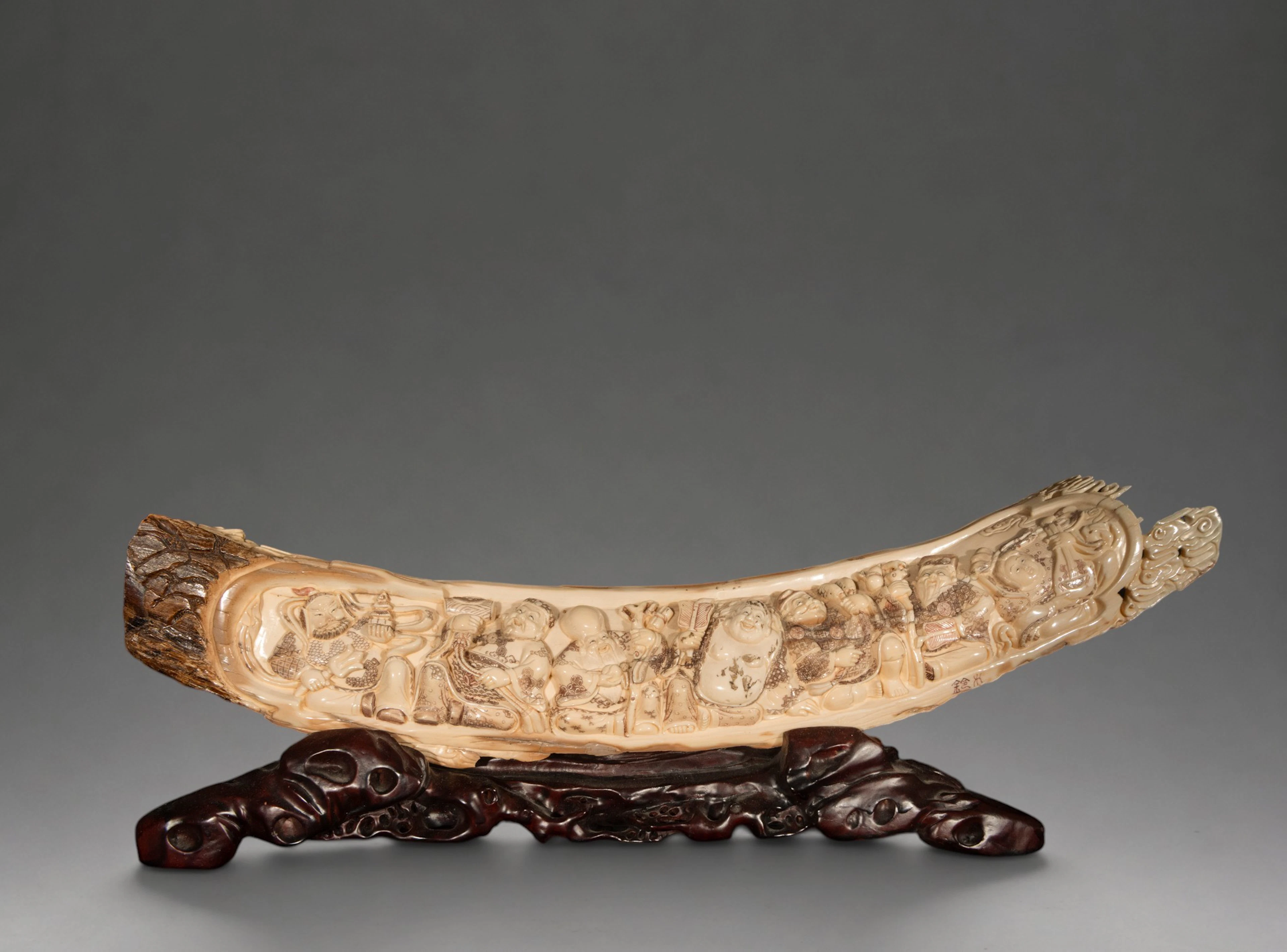 Mammoth tusk carved with figures of deities, signed – China – 20th century