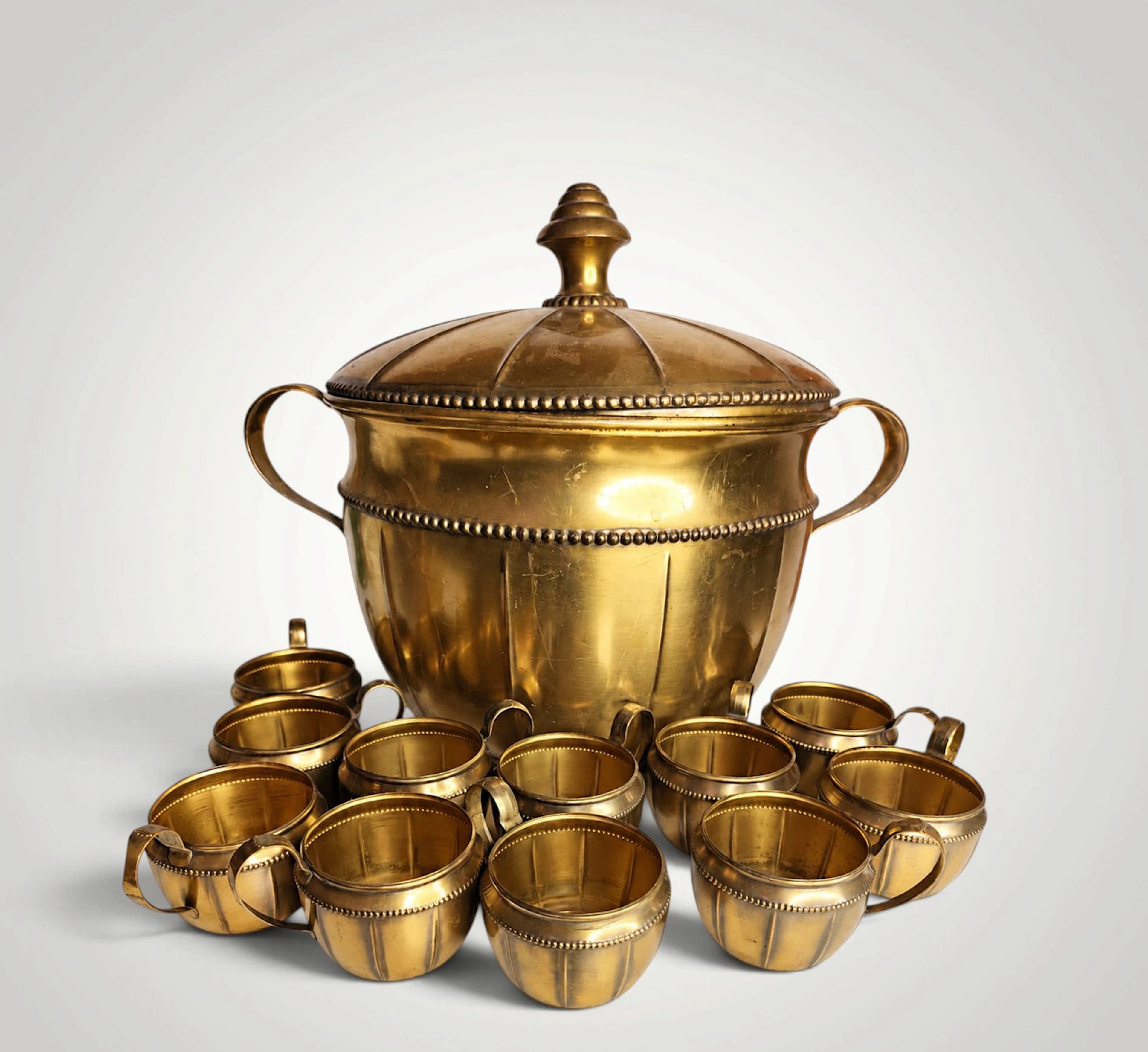 Large brass punch bowl with 11 brass cups. Germany, early 1900s