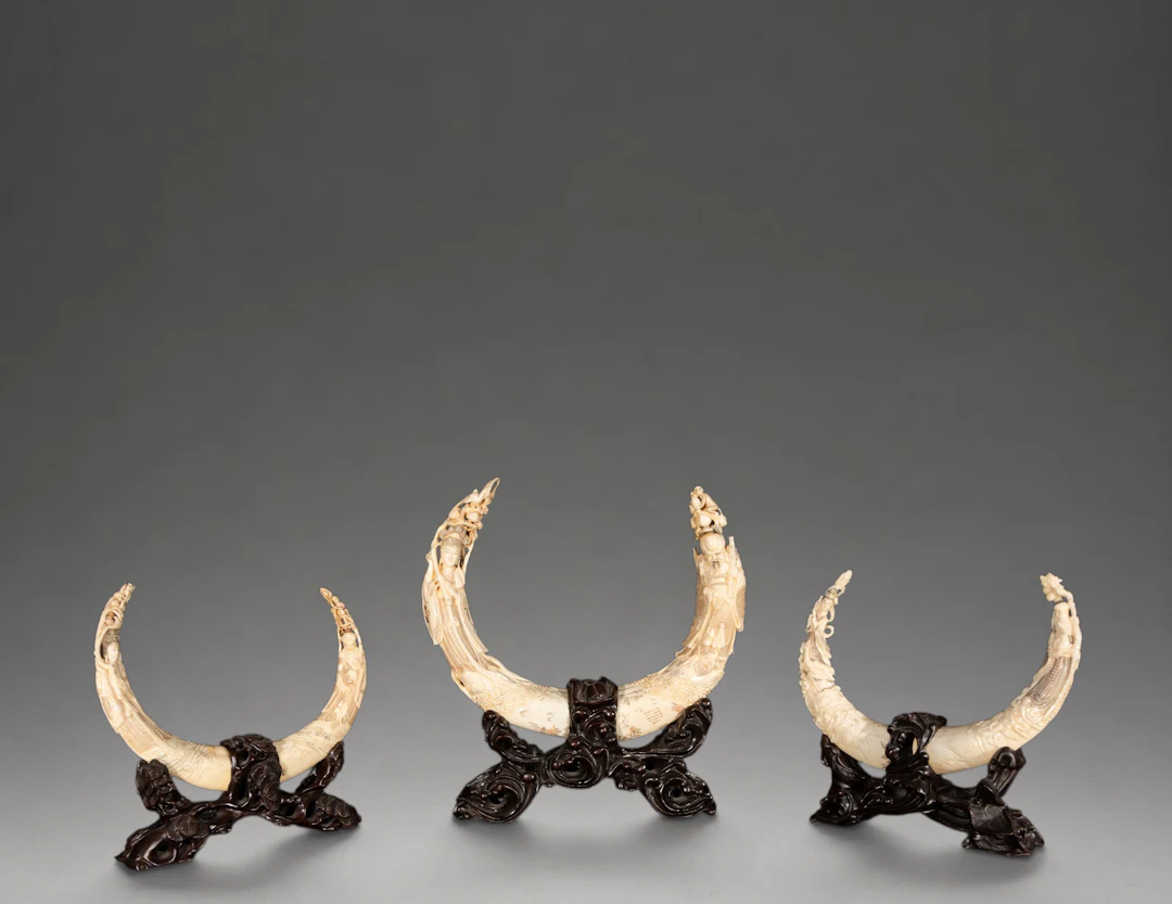 Set of three hippopotamus tusks carved with figures – China – 20th century