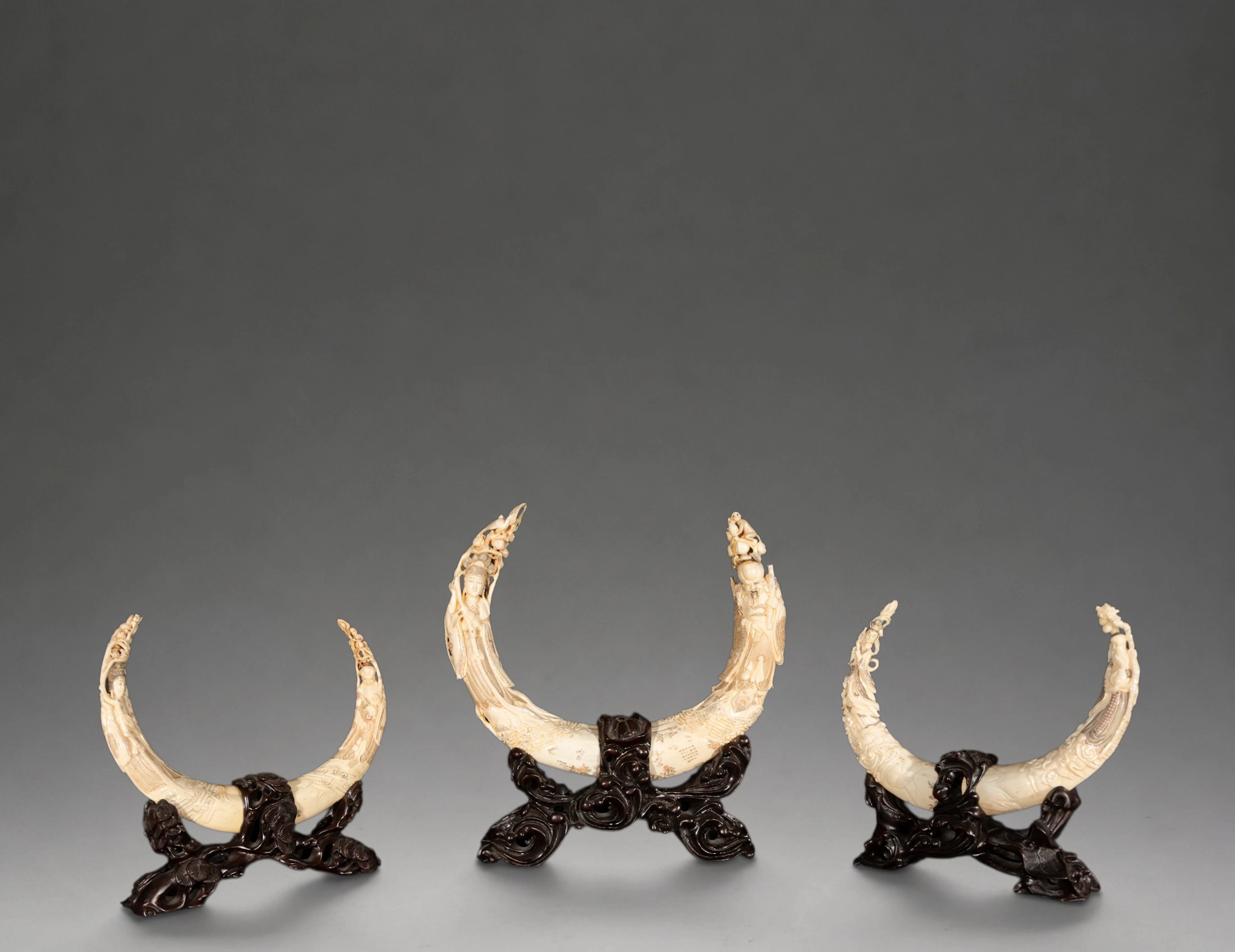 Set of three hippopotamus tusks carved with figures – China – 20th century
