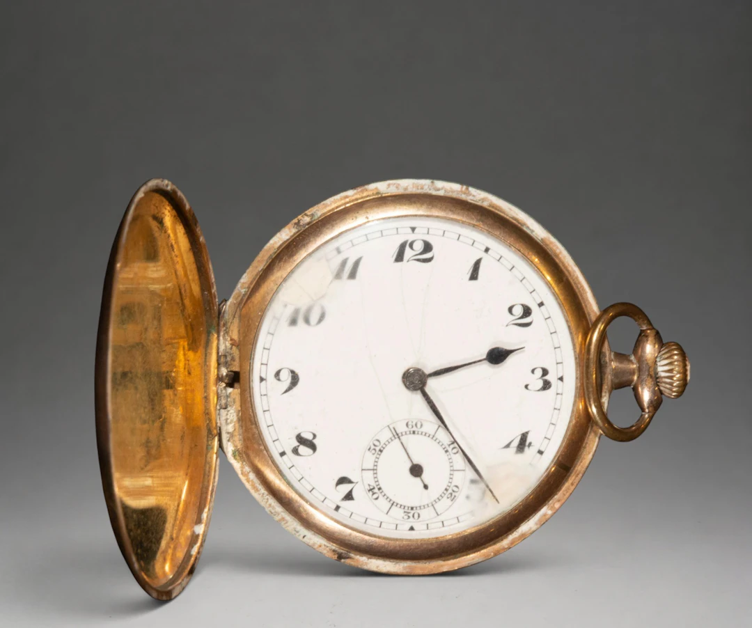 Gold pocket watch with white dial