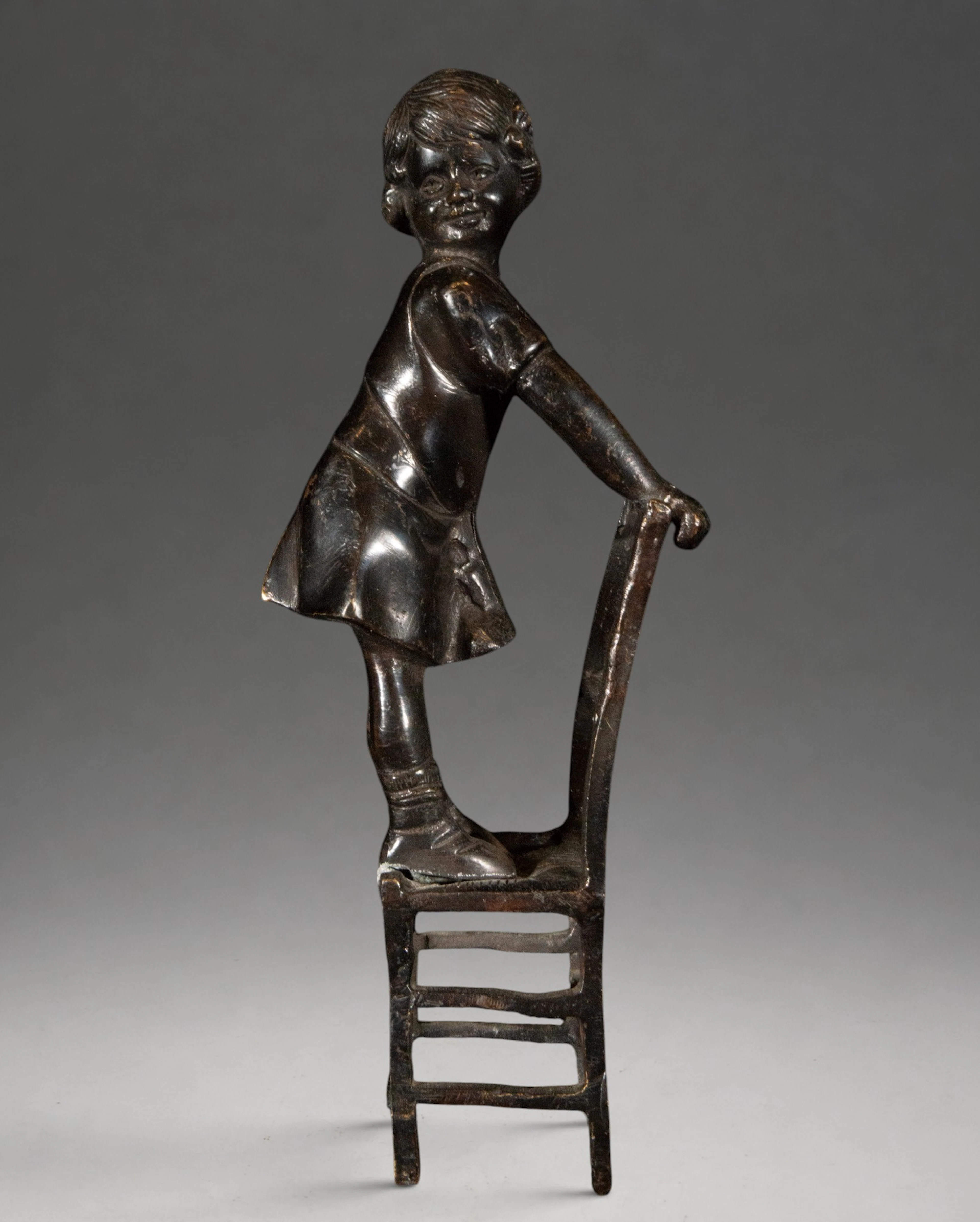 Child figure on a chair – 20th century