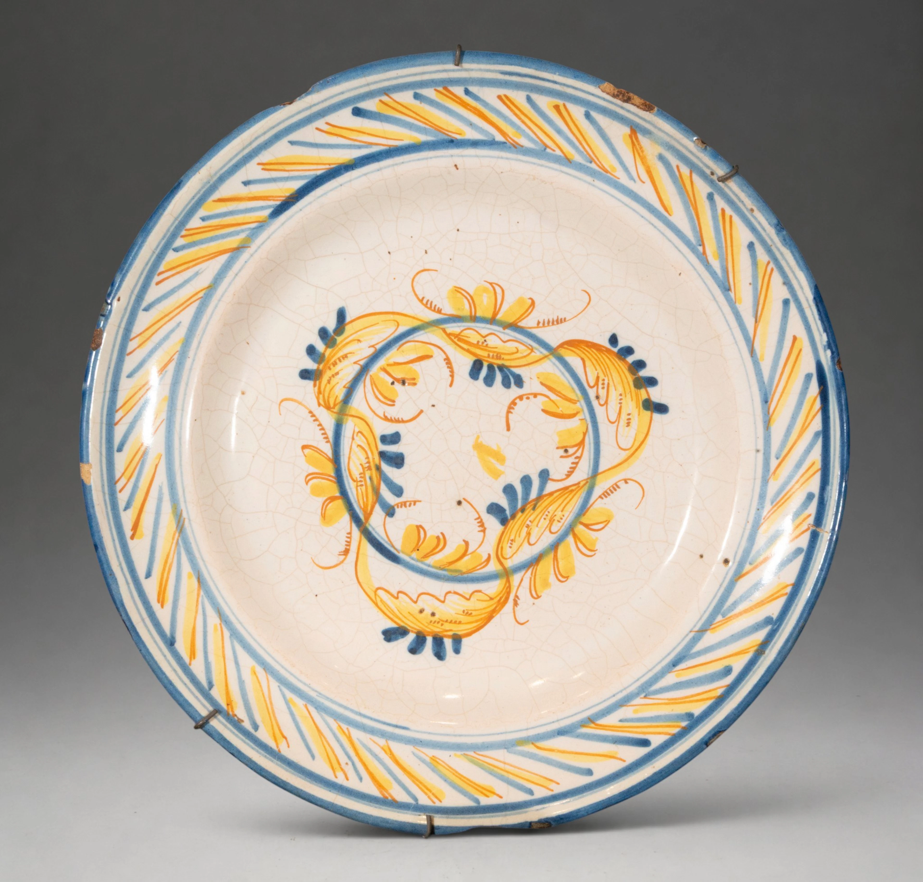 MANISES CERAMICS - Plate with stylized floral decoration in blue and yellow