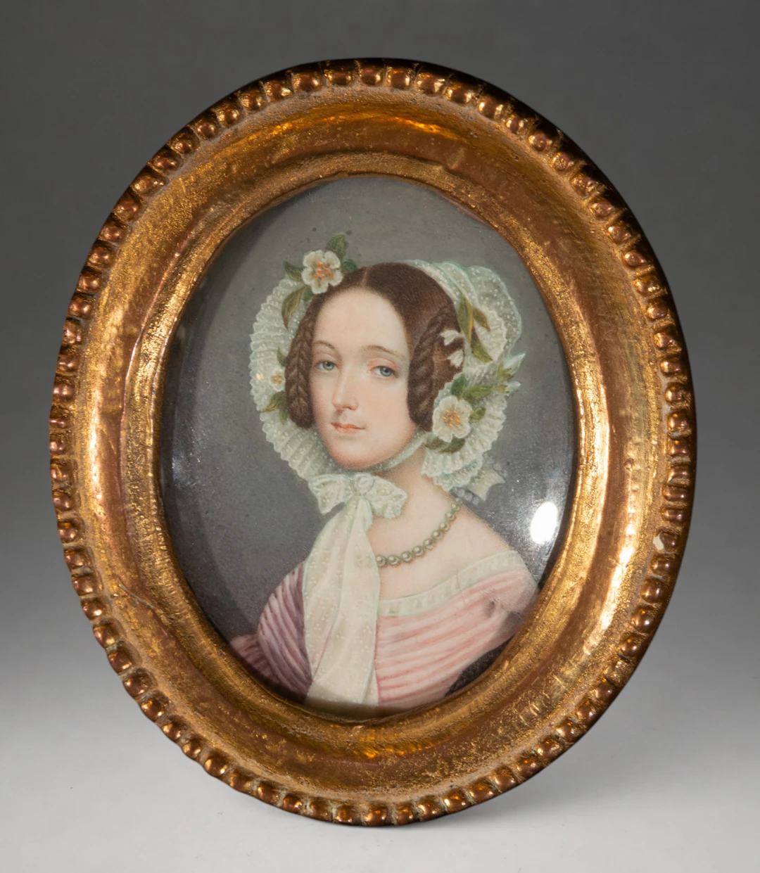 Portrait of a lady with a lace cap and flowers – European School – 19th century