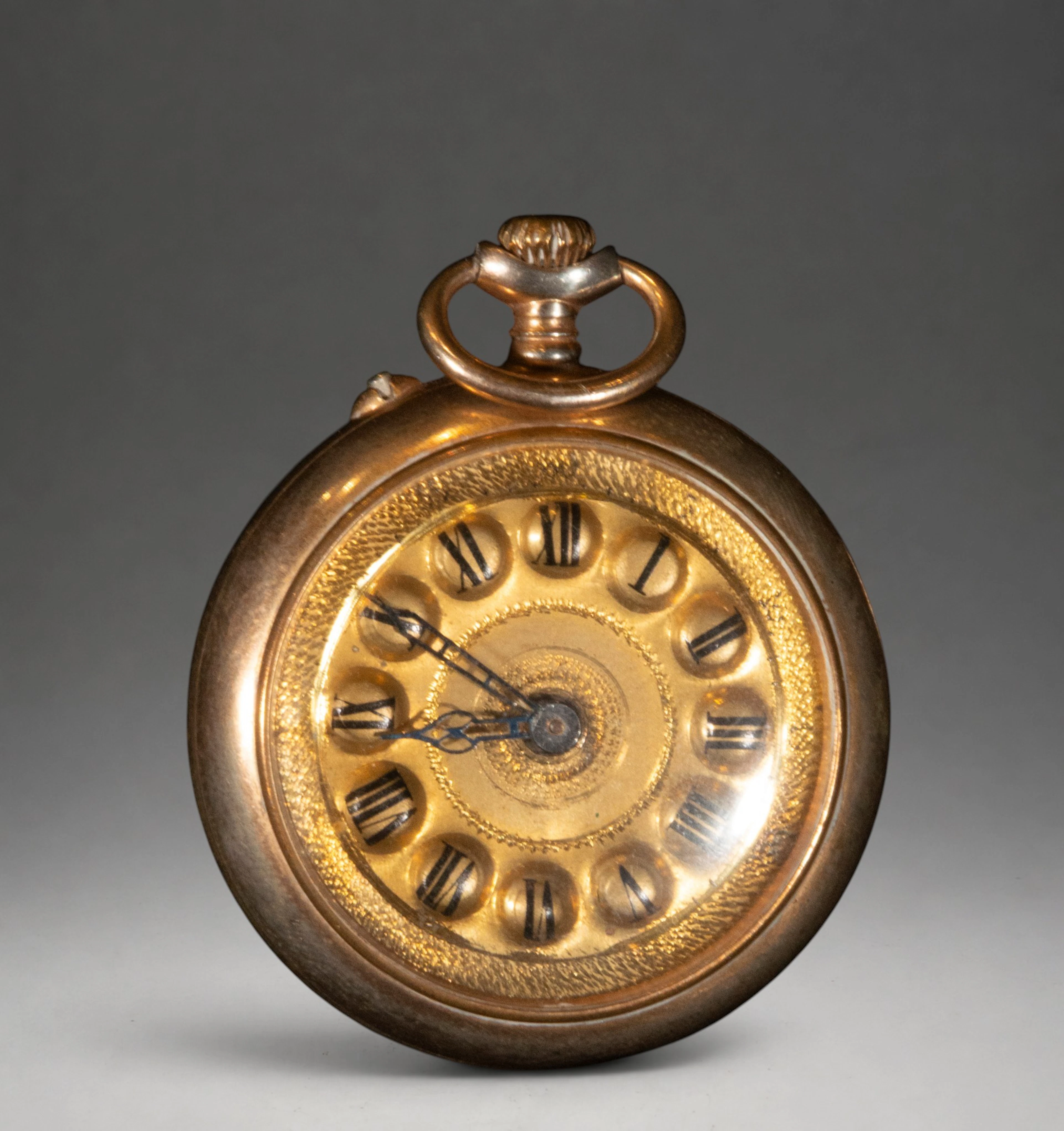 Gold pocket watch with ornate dial