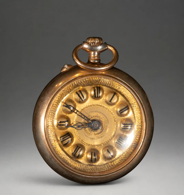 Gold pocket watch with ornate dial