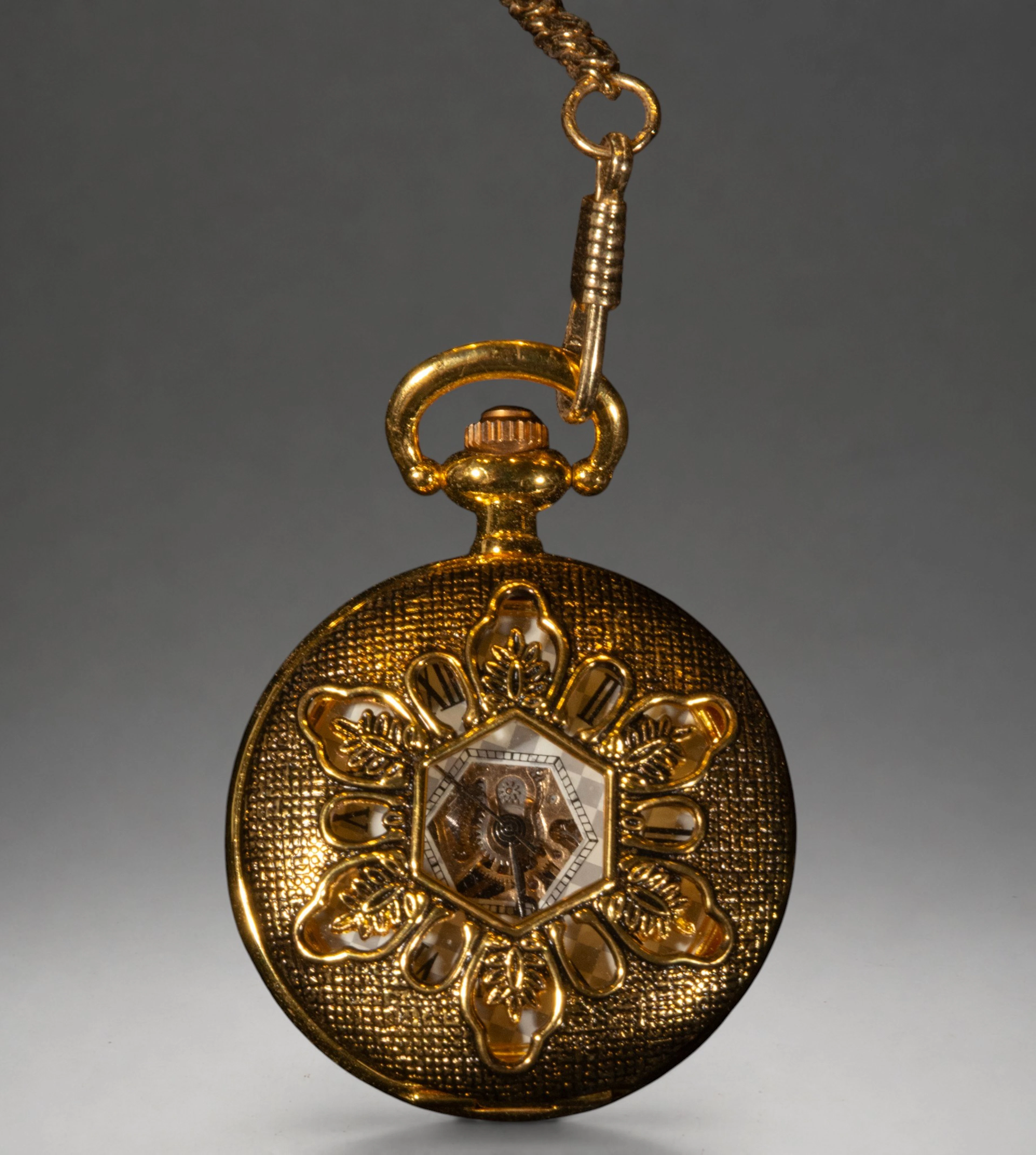 Gold pocket watch with floral cover and chain