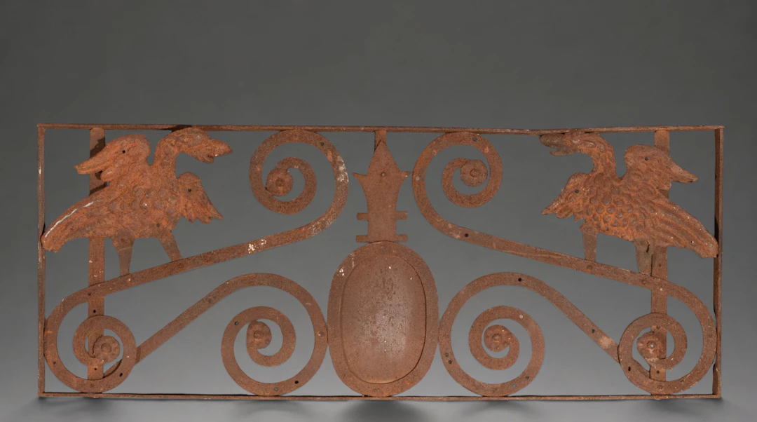 Wrought iron finial with facing birds and scrolls