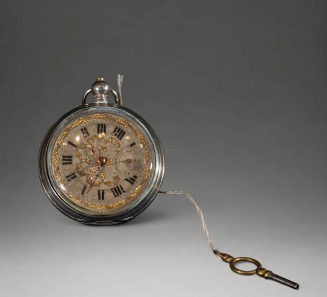 Pocket watch with gold dial and chain