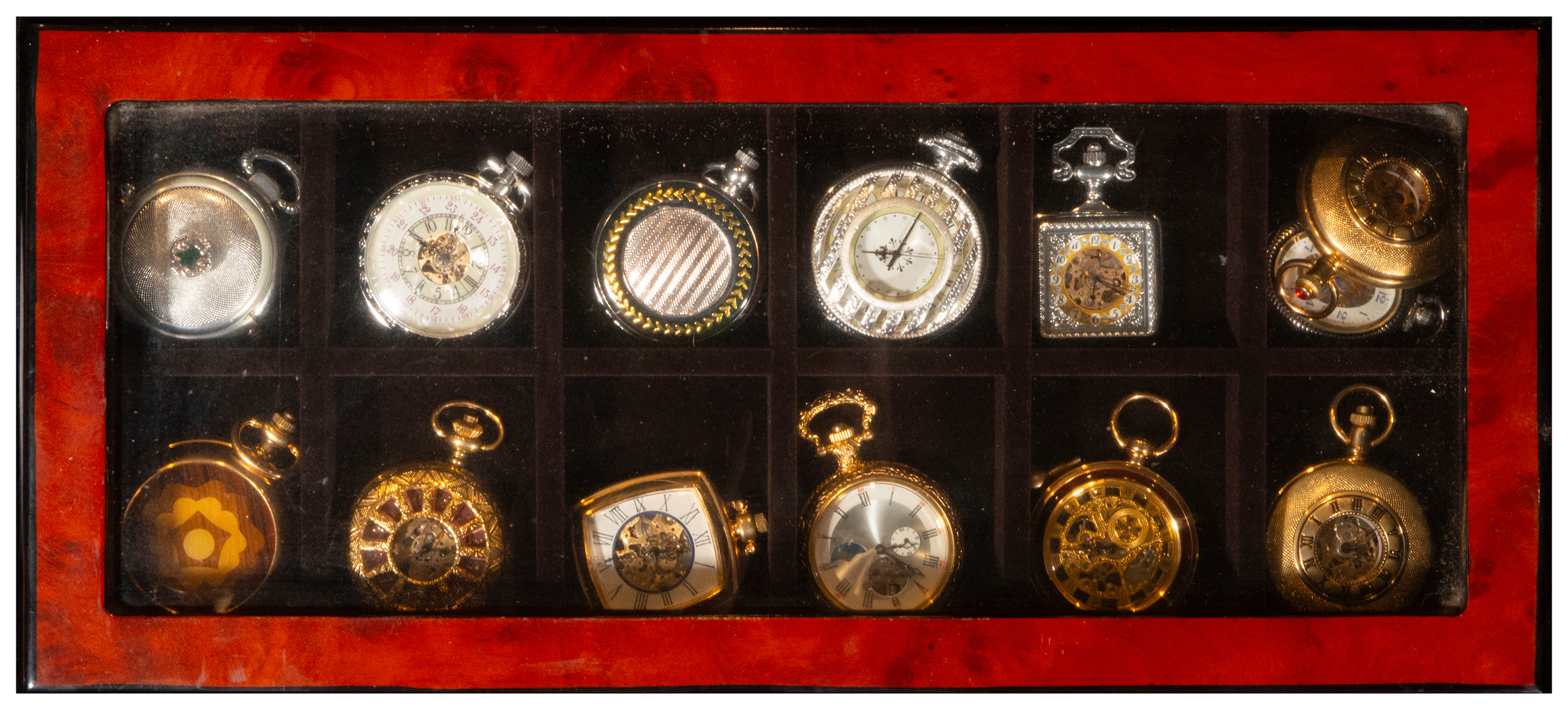 Collection of twelve pocket watches in a compartmentalized case