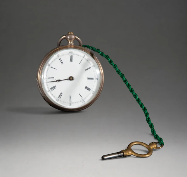 Small pocket watch with green chain