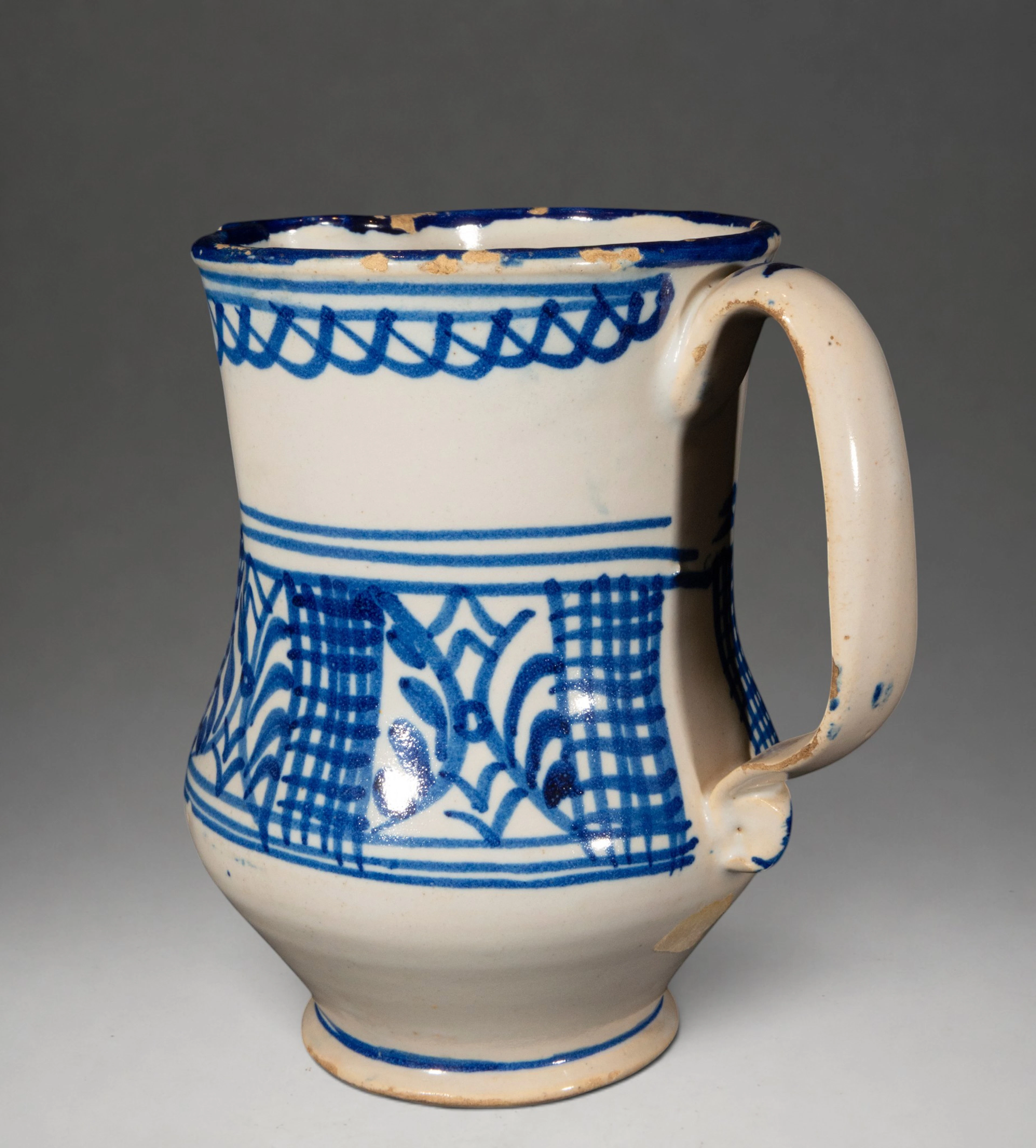 MANISES CERAMICS - Pitcher with plant and geometric decoration in blue