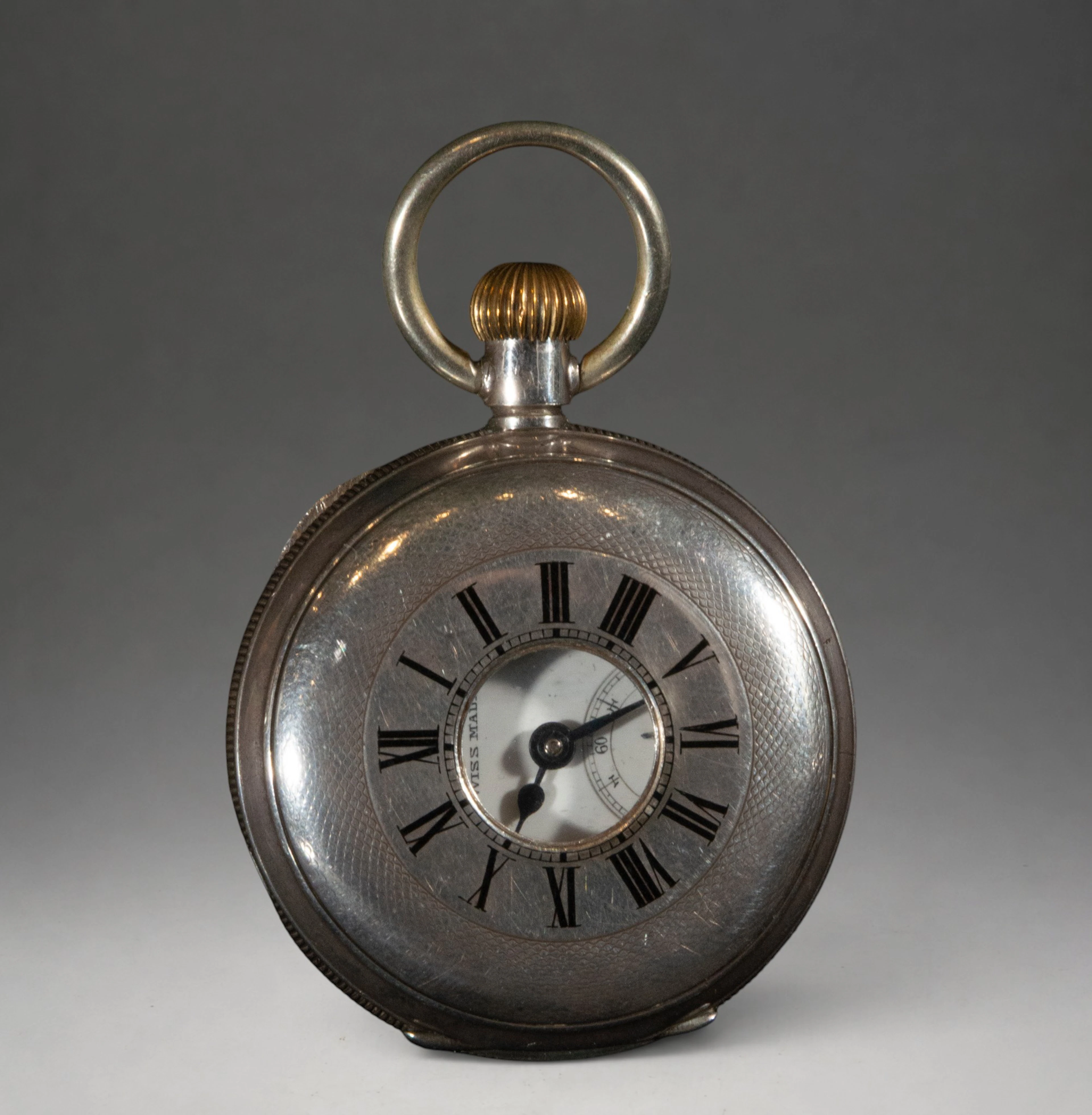 Pocket watch with Roman numeral dial and metal center