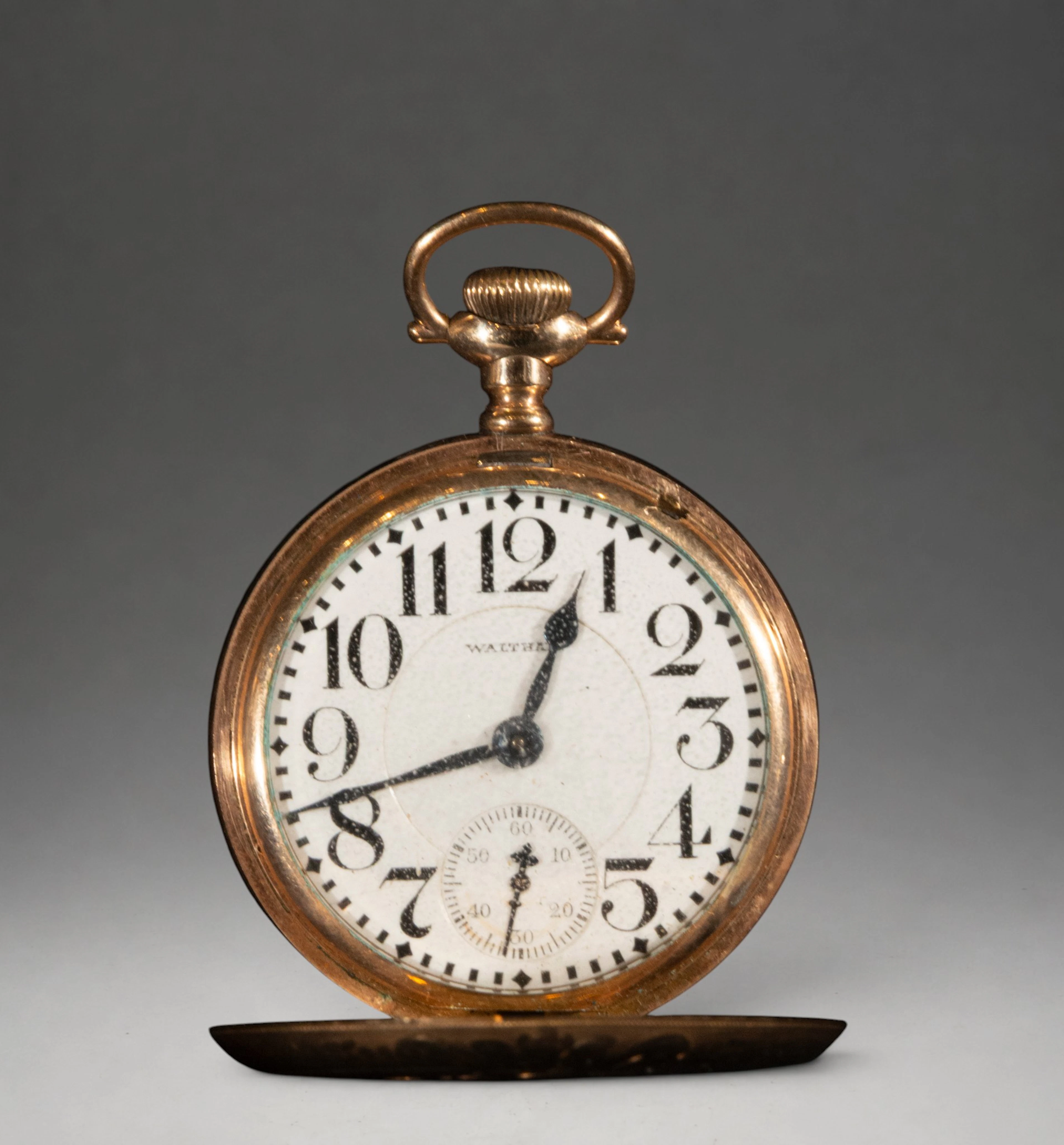 Pocket watch with gold case and Arabic numerals