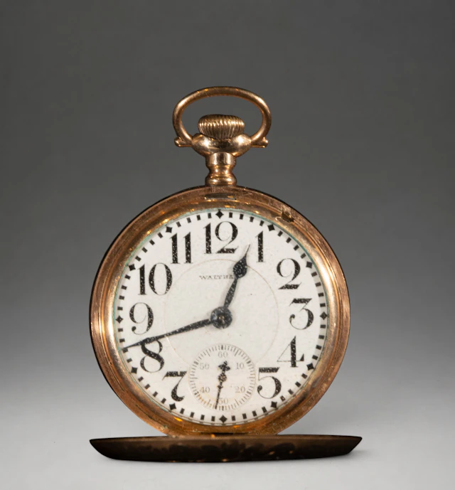 Pocket watch with gold case and Arabic numerals