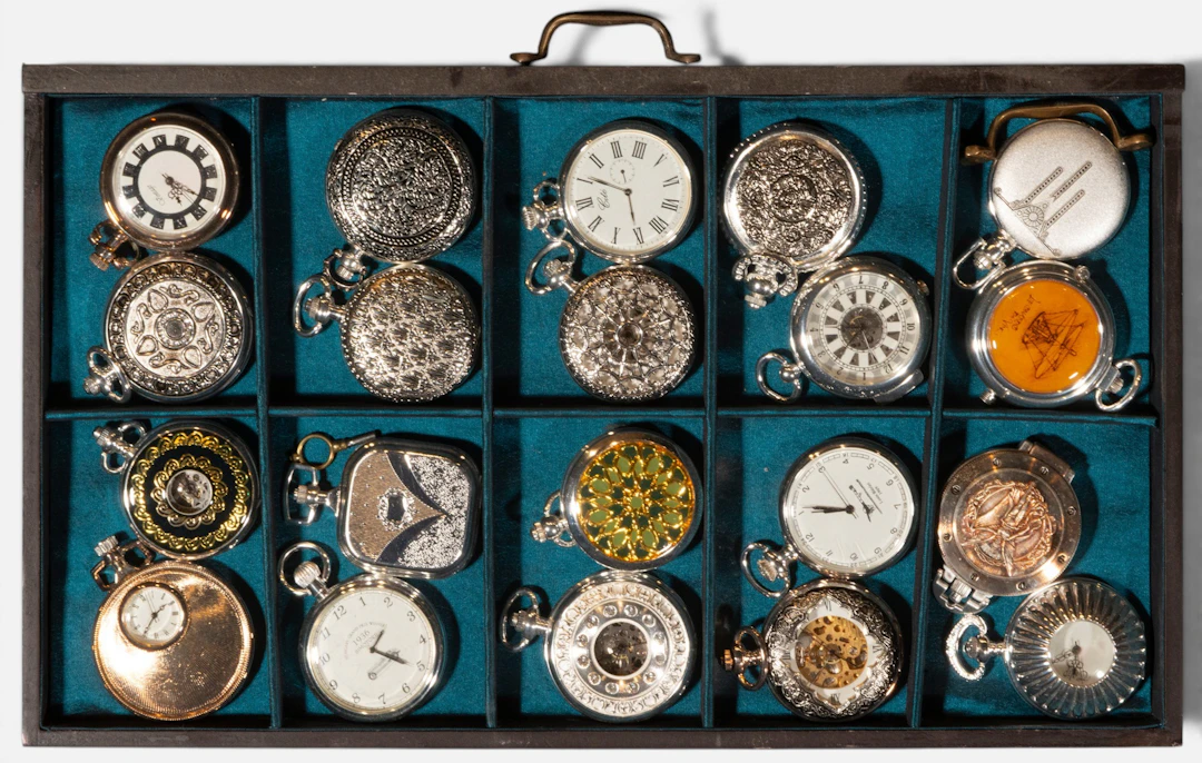 Collection of twenty pocket watches in a compartmentalized case