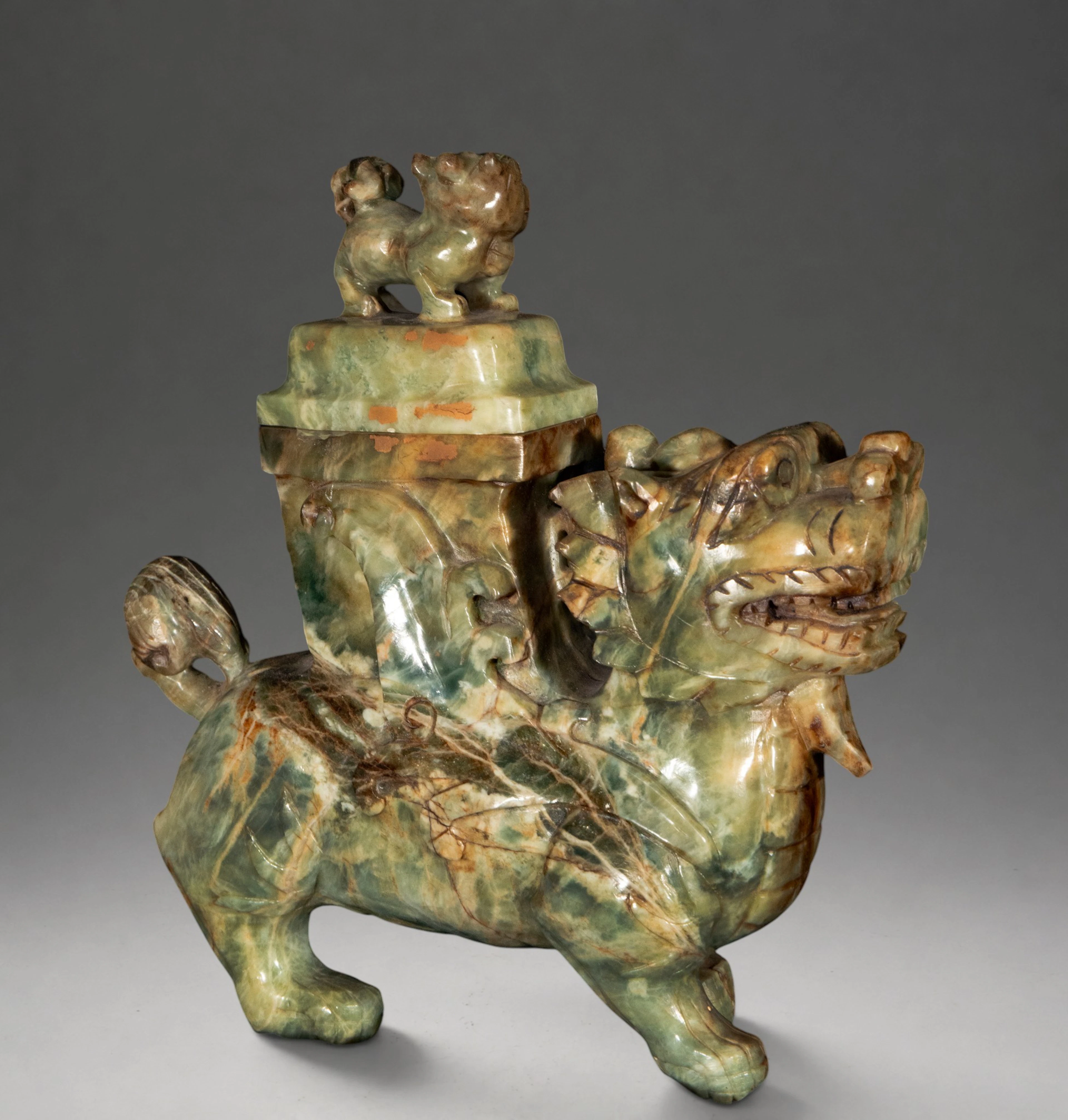 Buddhist lion with covered vessel – China