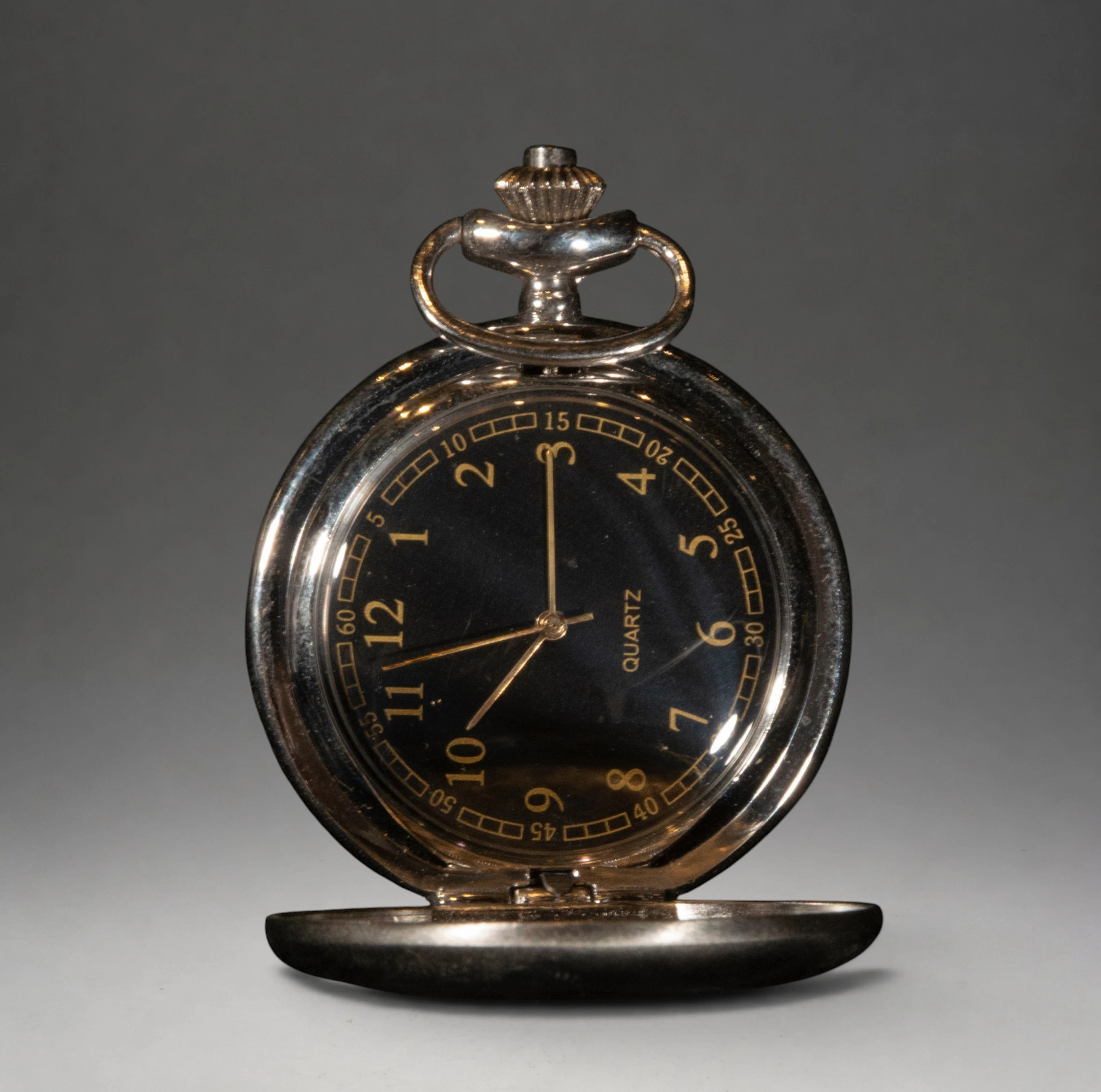 Pocket watch with black dial and Arabic numerals