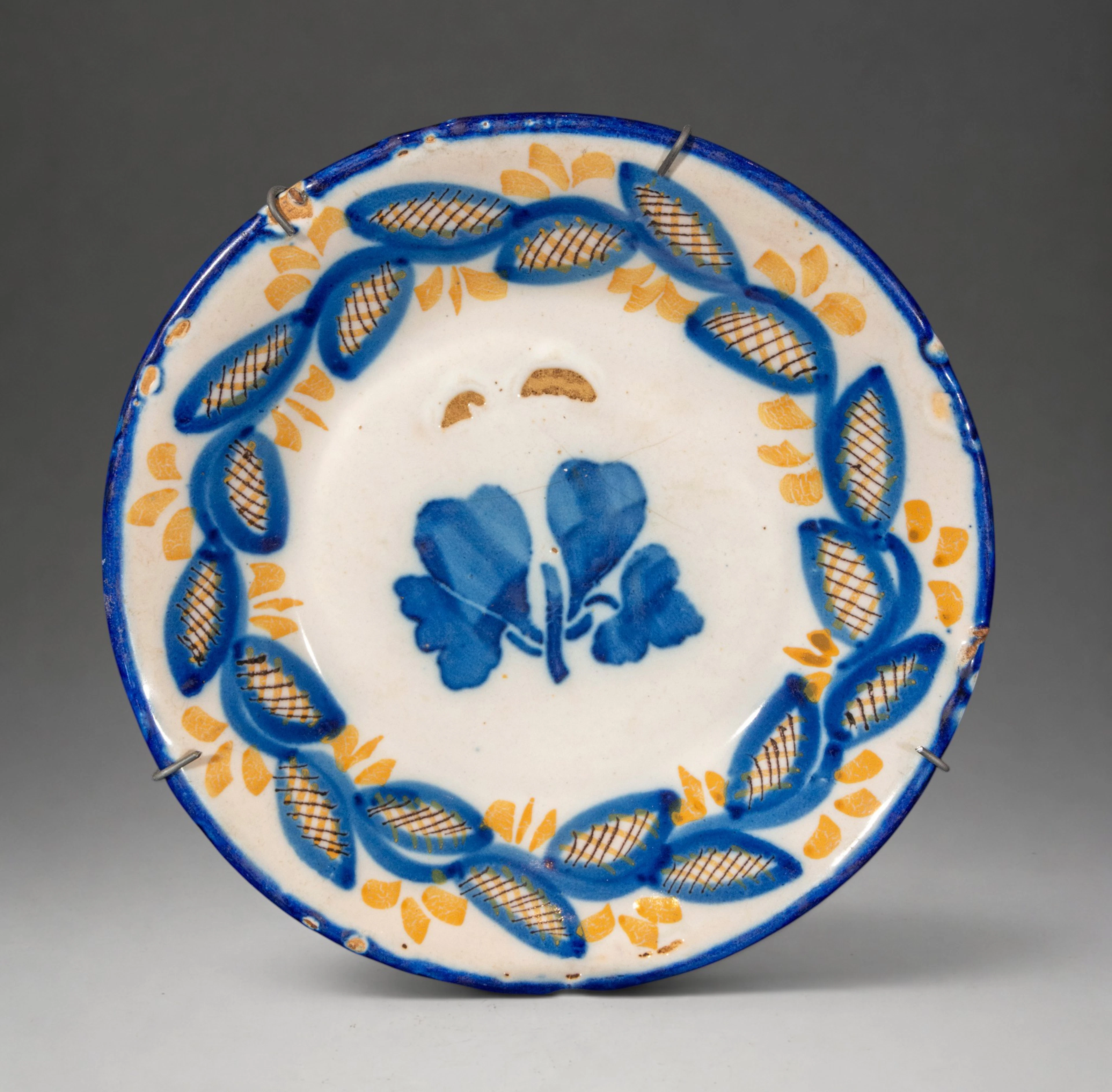 MANISES CERAMICS - Plate with plant decoration in blue and yellow
