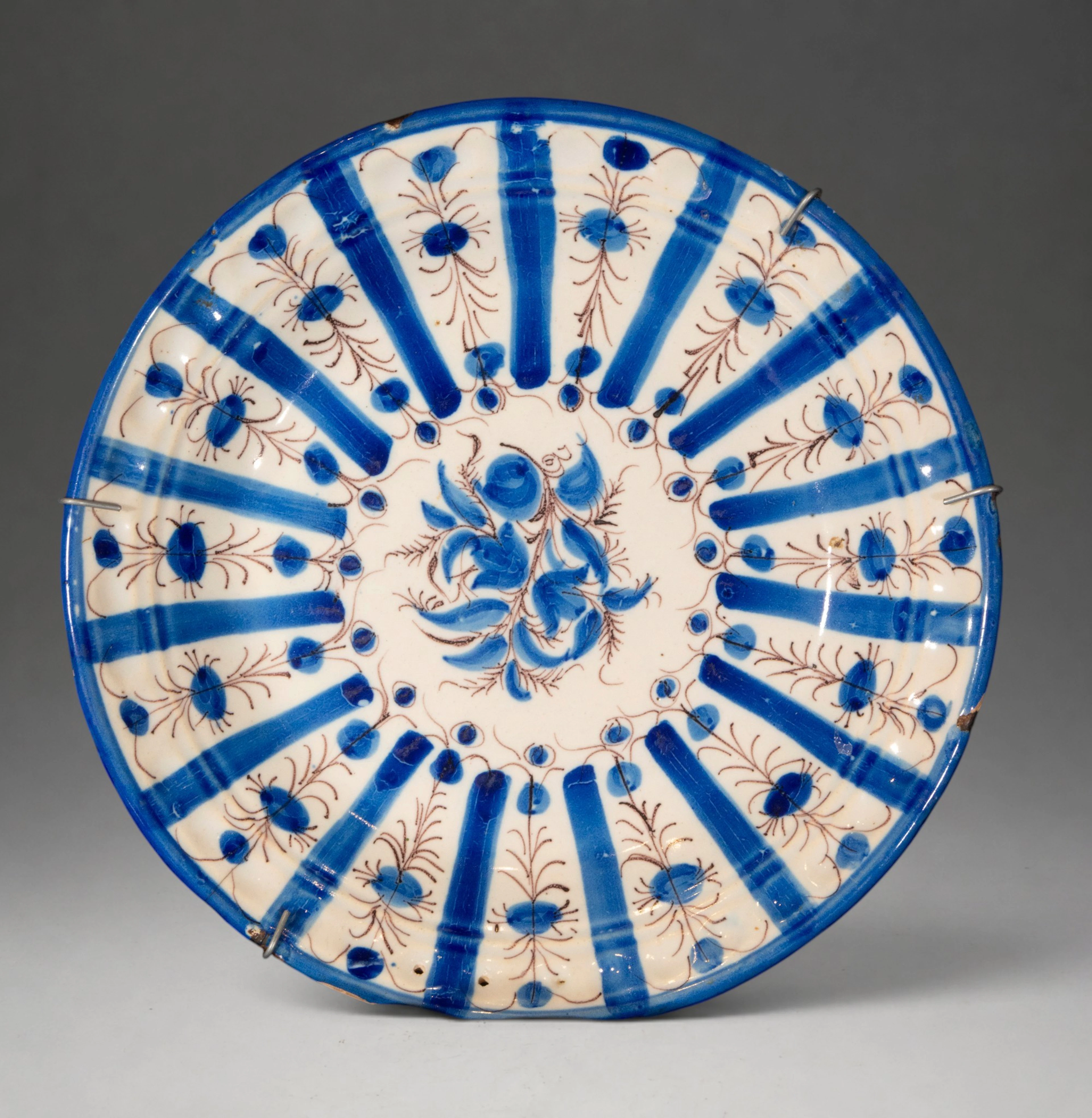 MANISES CERAMICS - Plate with geometric and floral decoration in blue