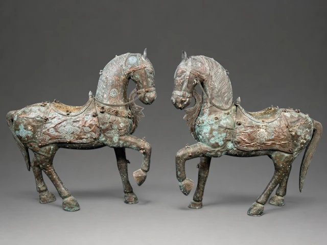 LARGE PAIR OF INDIAN HORSES MADE OF WOOD AND COVERED IN COPPER AND BRASS