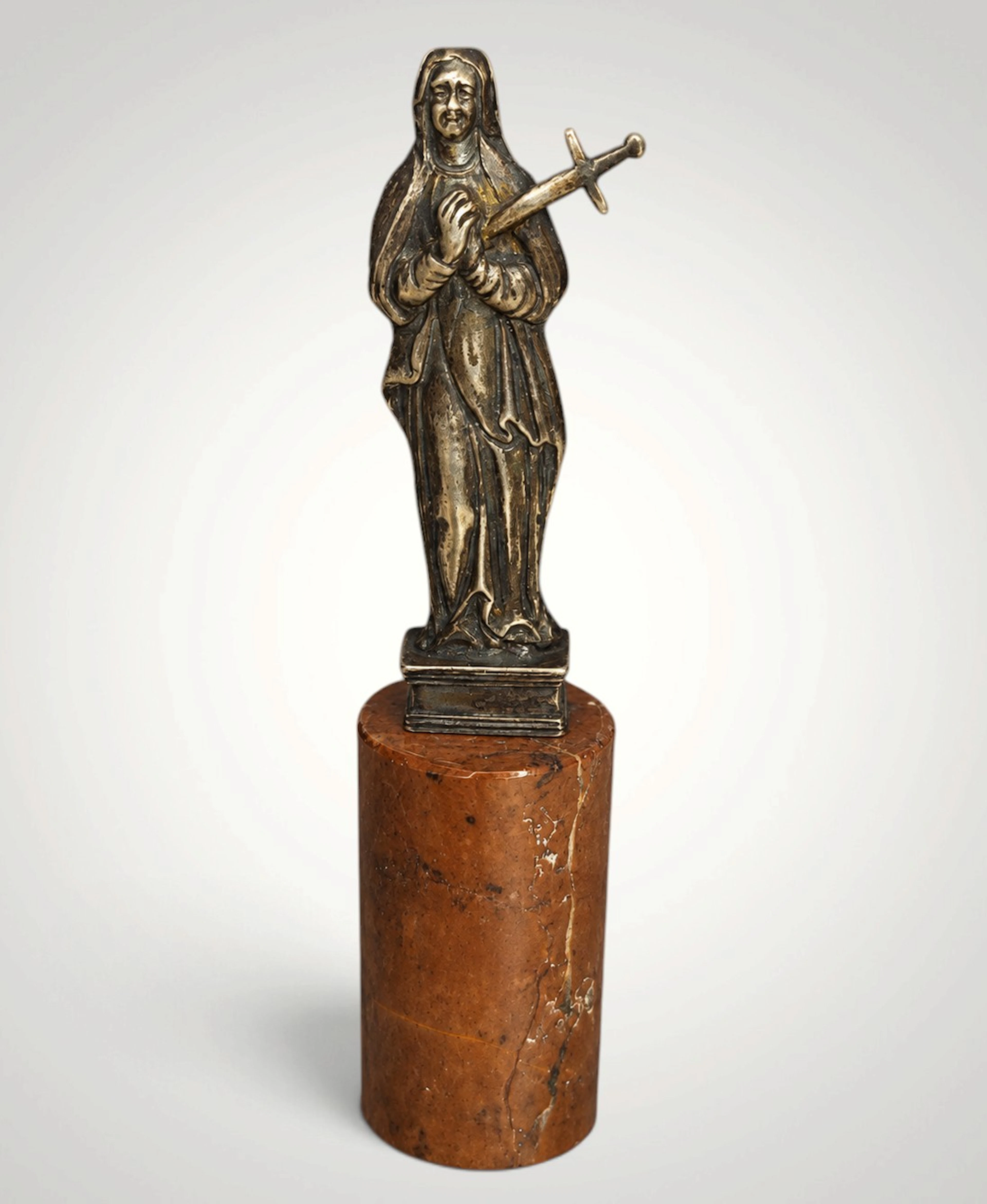 18th-century silver figure of the Virgin of Sorrows on a red marble base