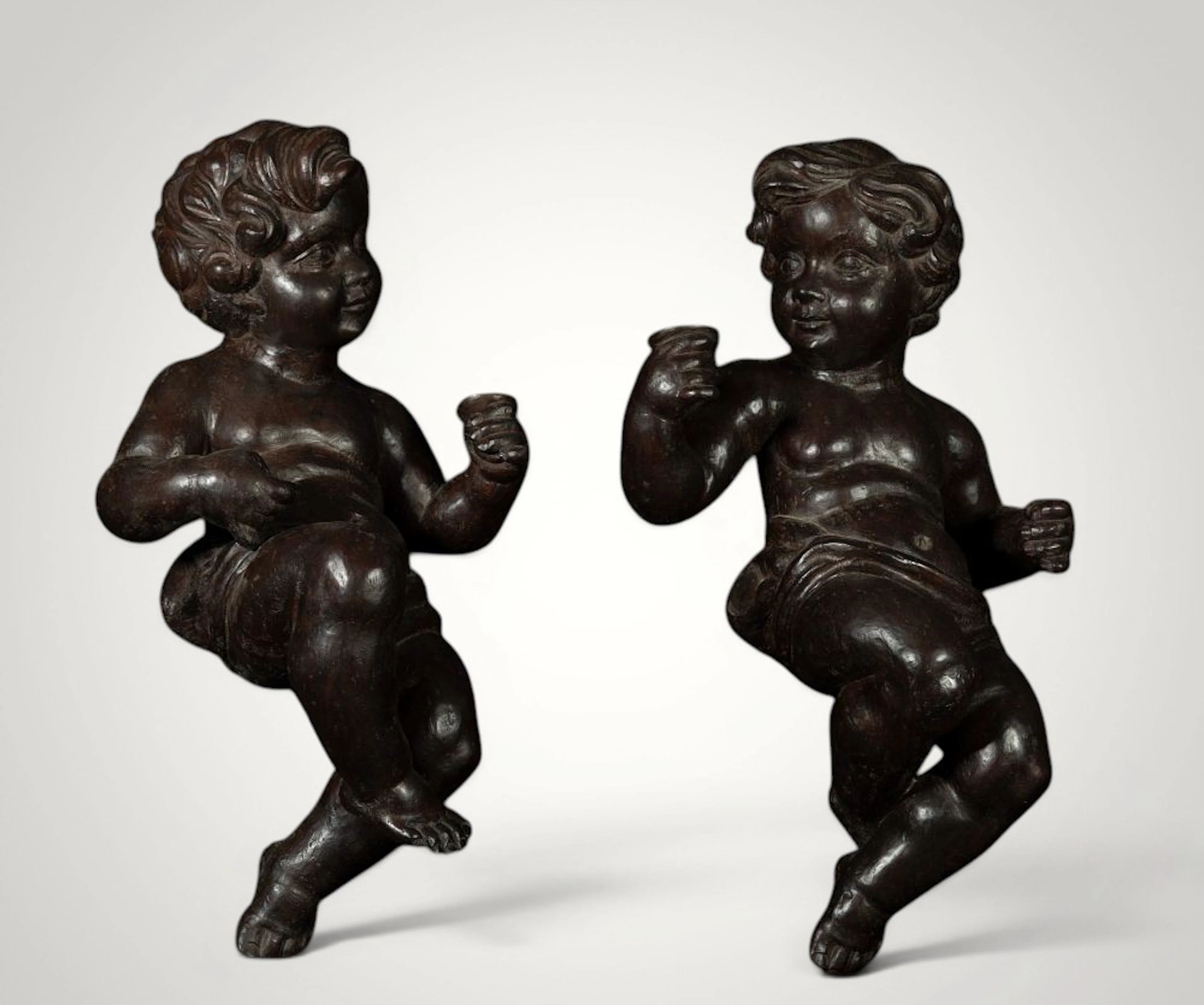 Beautiful pair of little angels hanging on the wall in natural wood