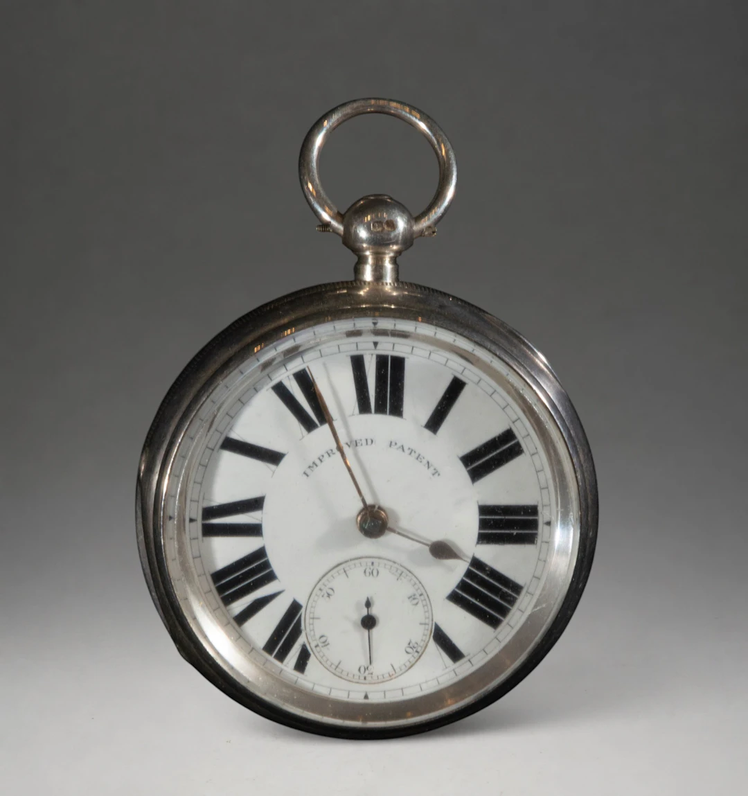 Pocket watch with white dial and Roman numerals